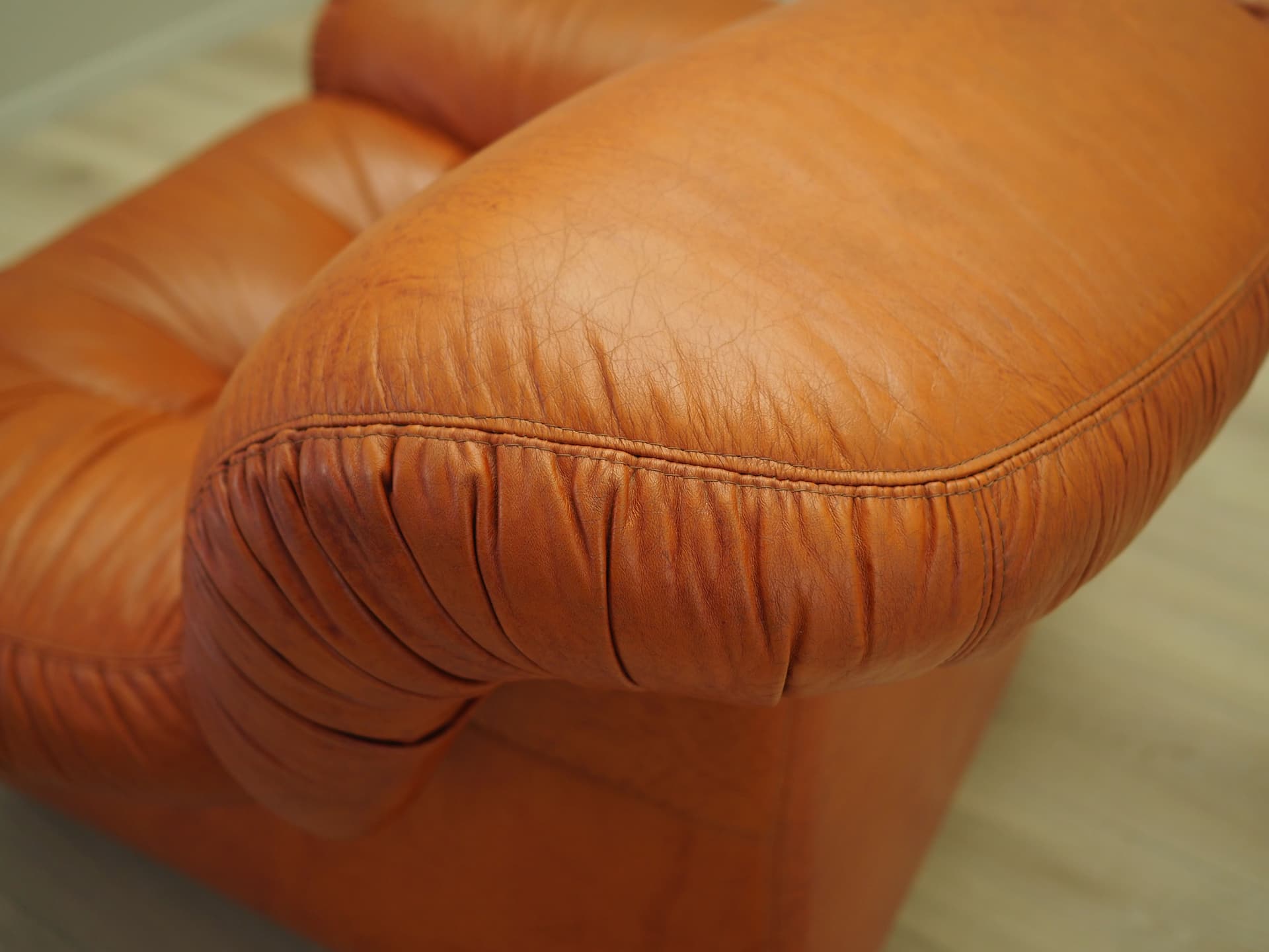 Lounge chair, burnt orange, natural leather, Italy, 1970s. - 81739