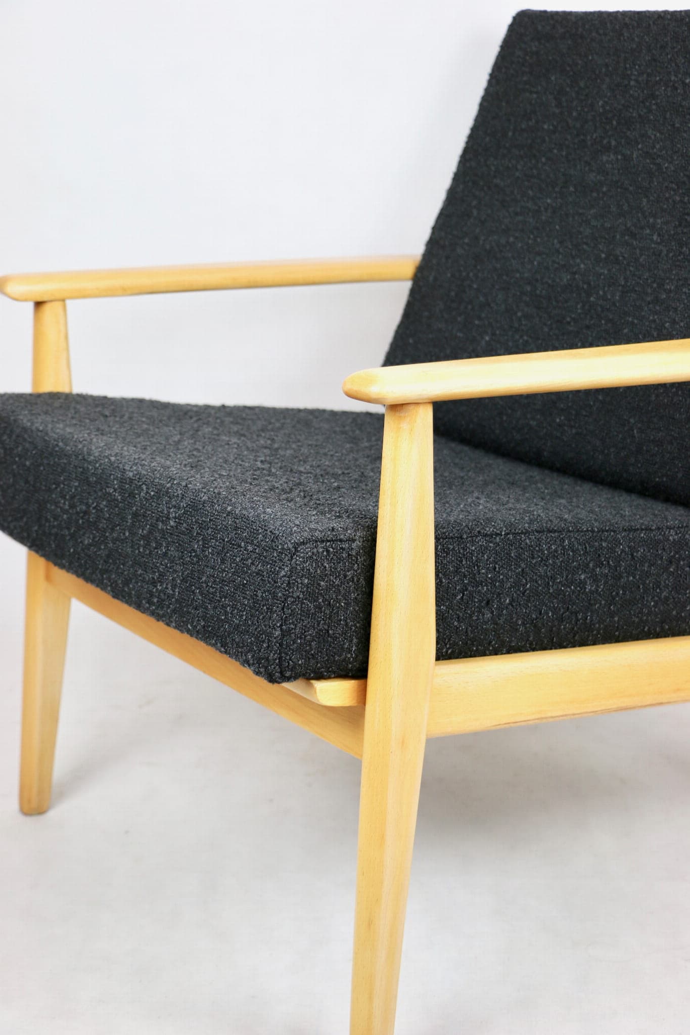 Armchair, black boucle, light wood, Denmark, 1970s. - 107346