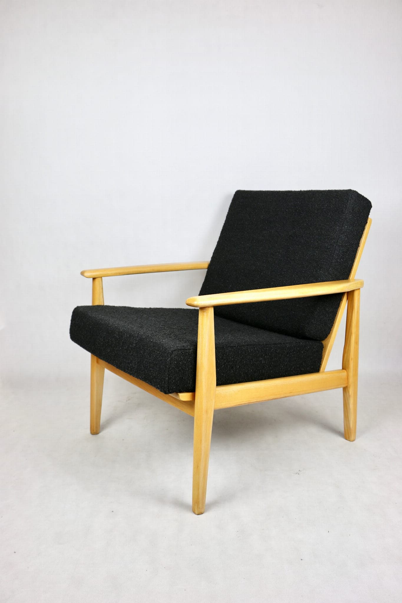 Armchair, black boucle, light wood, Denmark, 1970s. - 107345