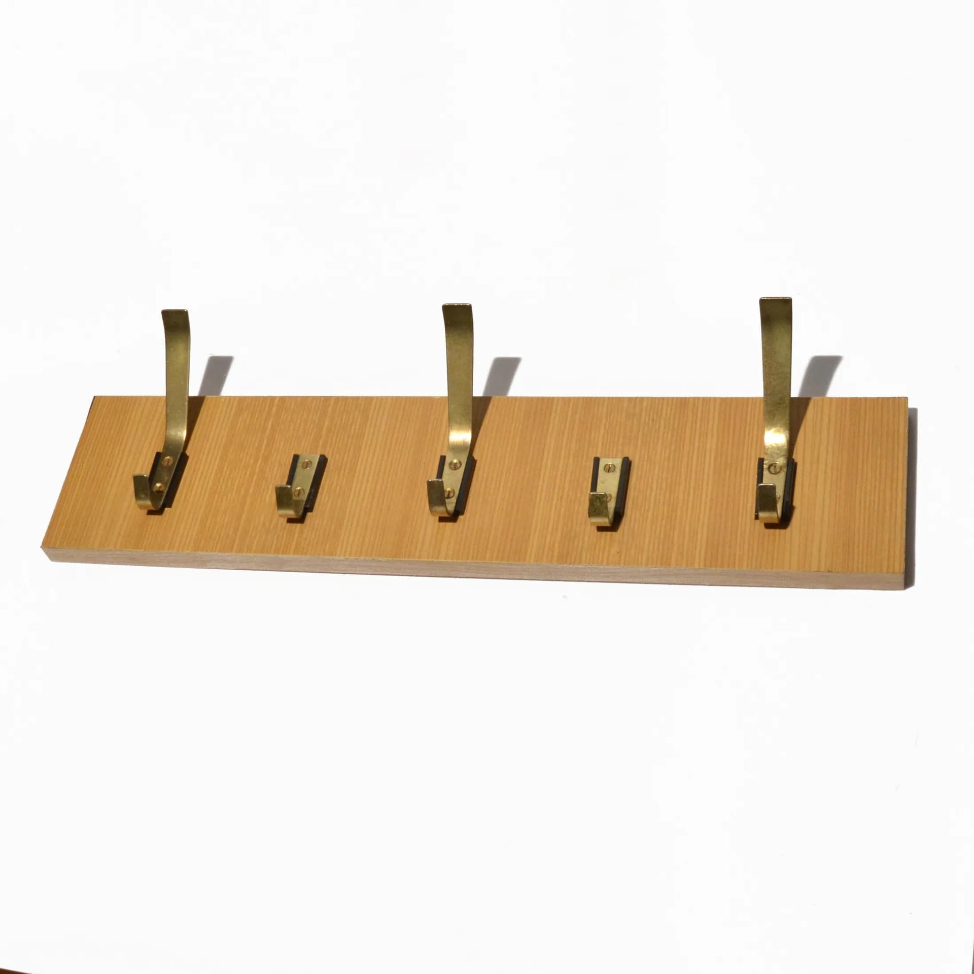 Wall-mounted rack, brown plywood, golden brass, VEB Deutsche Werkstätten Hellerau, Germany, 1970s. - 126798