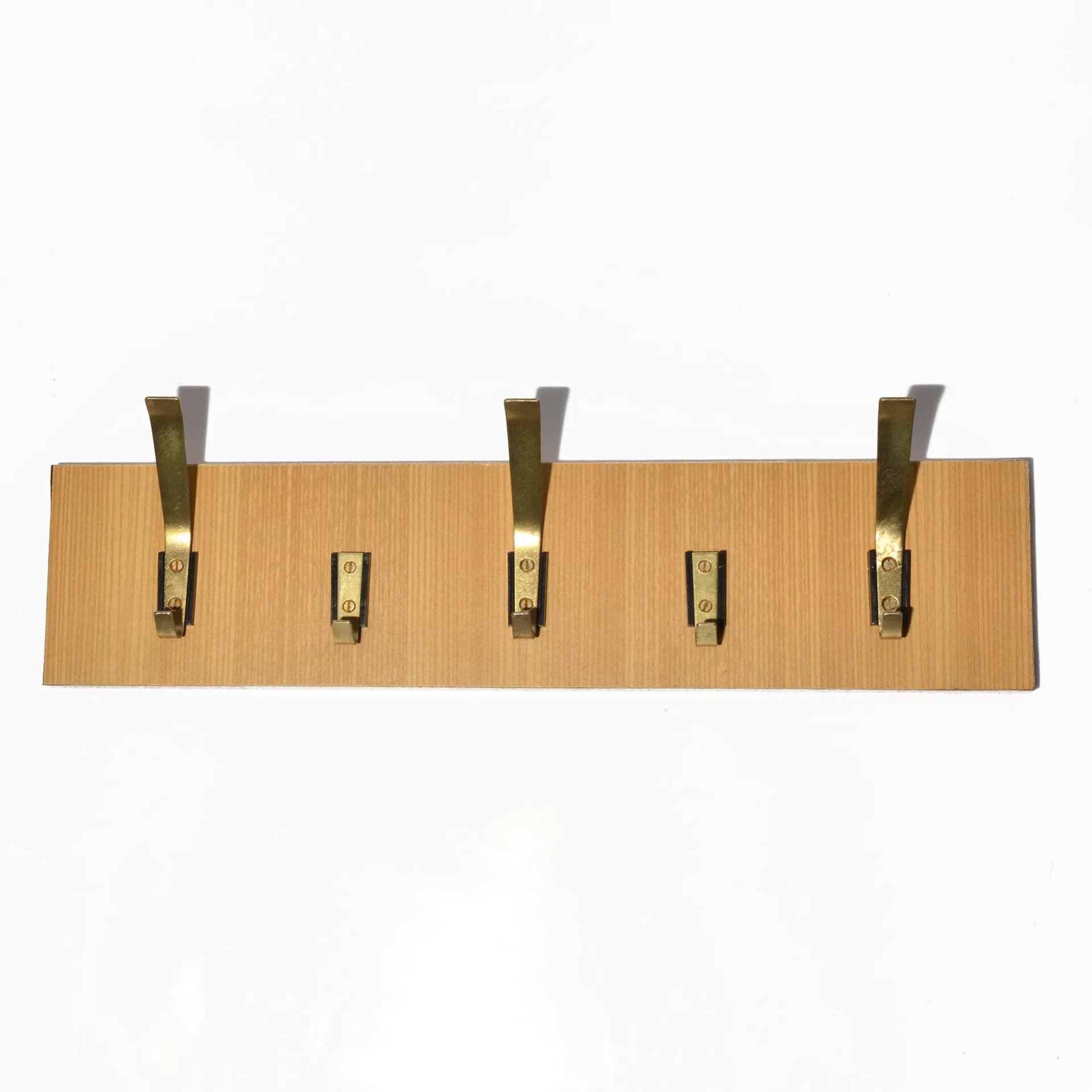 Wall-mounted rack, brown plywood, golden brass, VEB Deutsche Werkstätten Hellerau, Germany, 1970s.