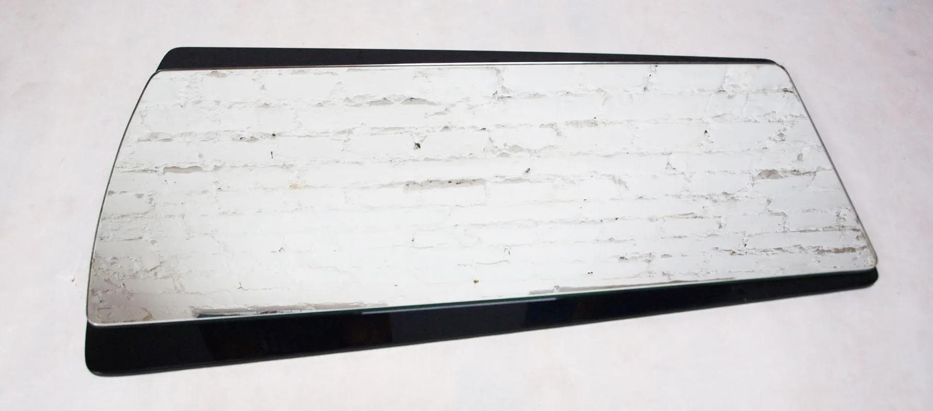 Wall mirror, black glass, Germany, 1960s. - 15970