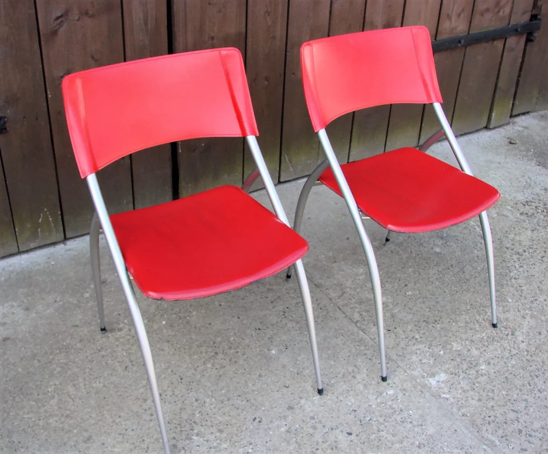 Pair of chairs, red, leather, brushed steel, Calligaris, Italy, 1990s. - 227205