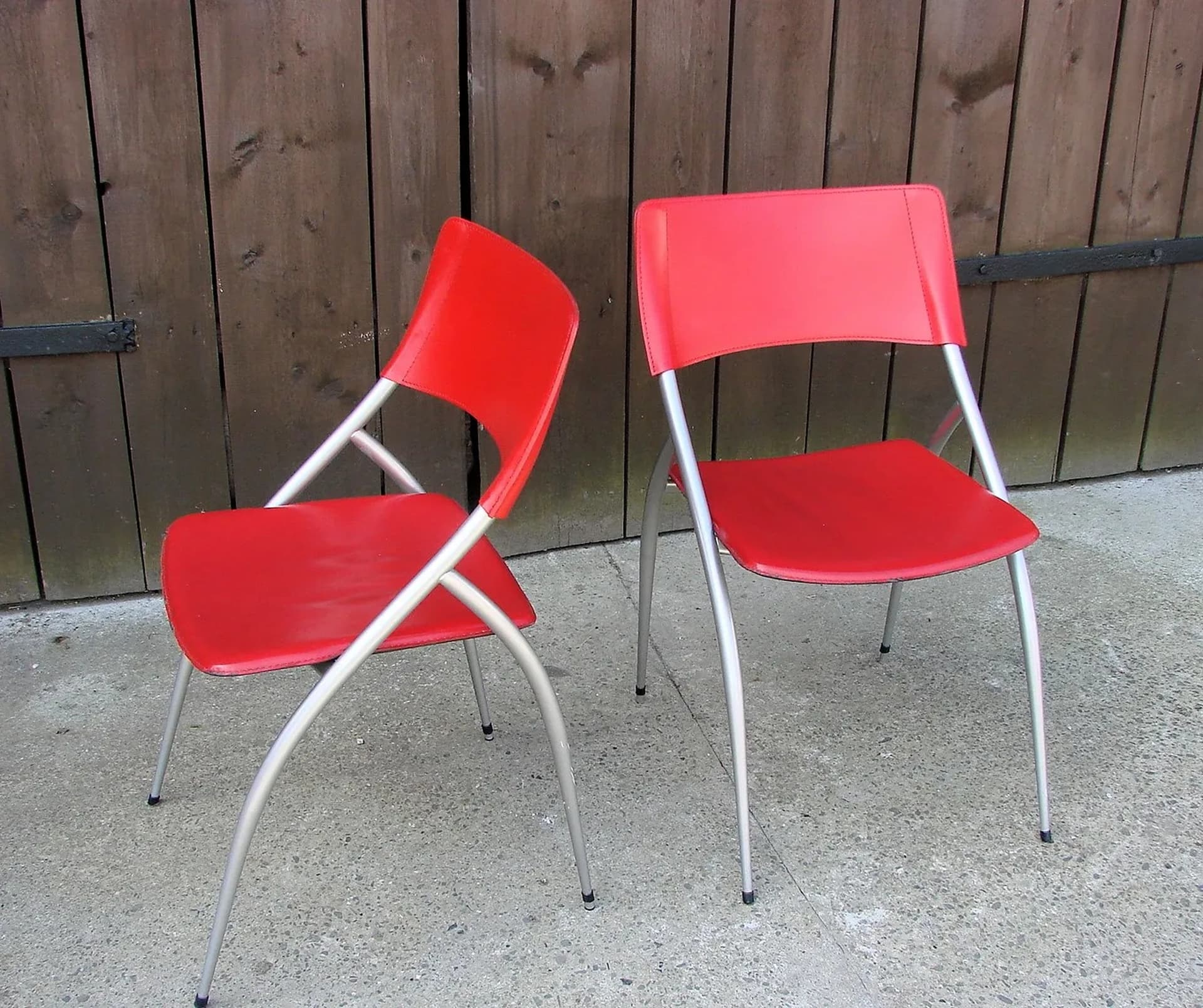 Pair of chairs, red, leather, brushed steel, Calligaris, Italy, 1990s. - 227206
