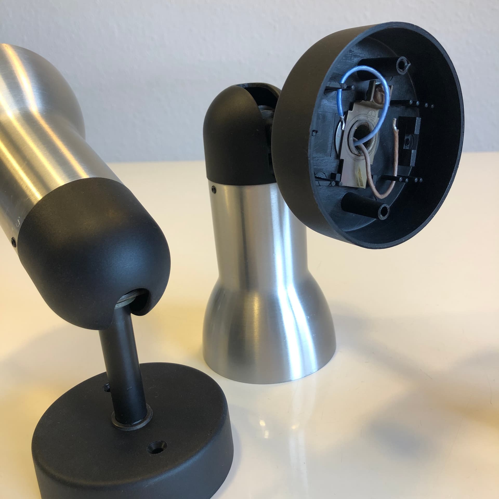 Pair of wall sconces, brushed silver aluminum, black metal, Staff Leuchten, Germany, 1970s. - 300620