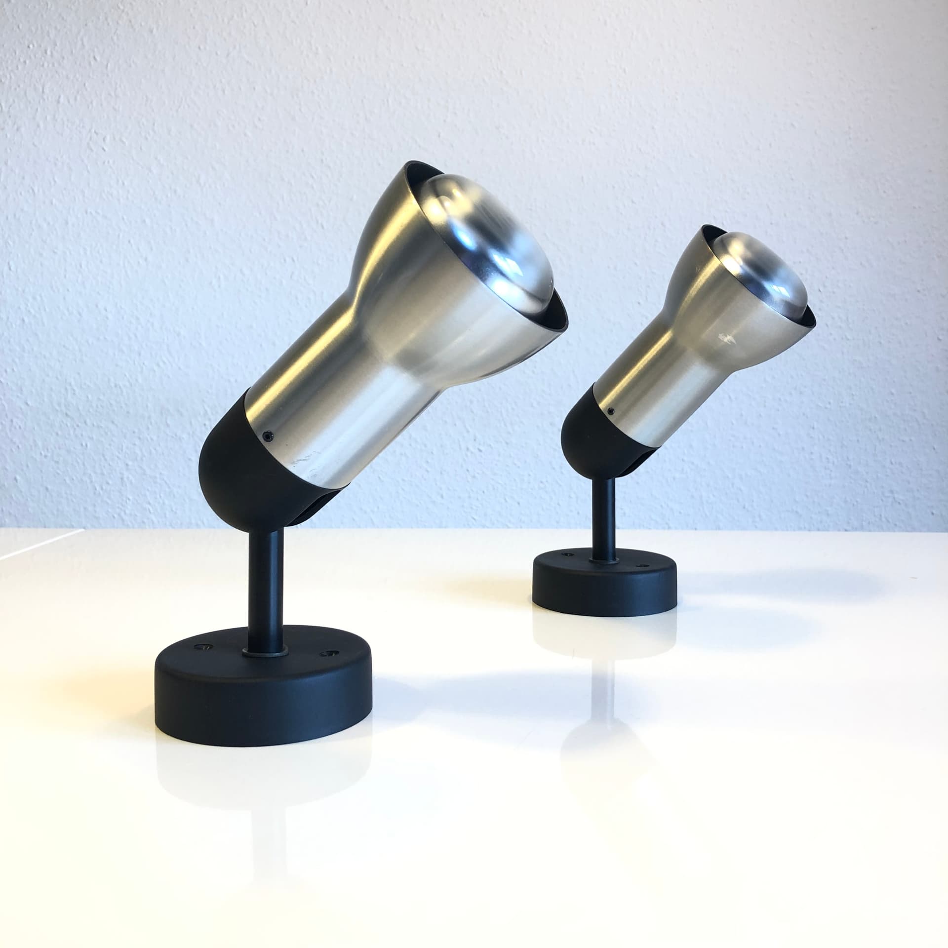 Pair of wall sconces, brushed silver aluminum, black metal, Staff Leuchten, Germany, 1970s. - 300623