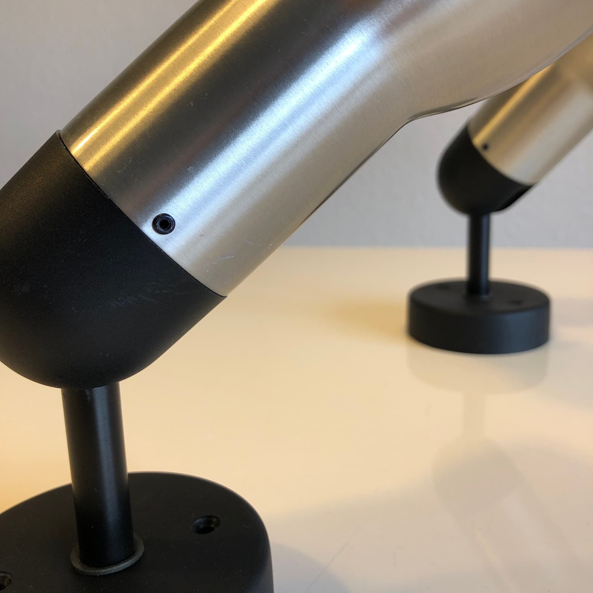 Pair of wall sconces, brushed silver aluminum, black metal, Staff Leuchten, Germany, 1970s. - 300624