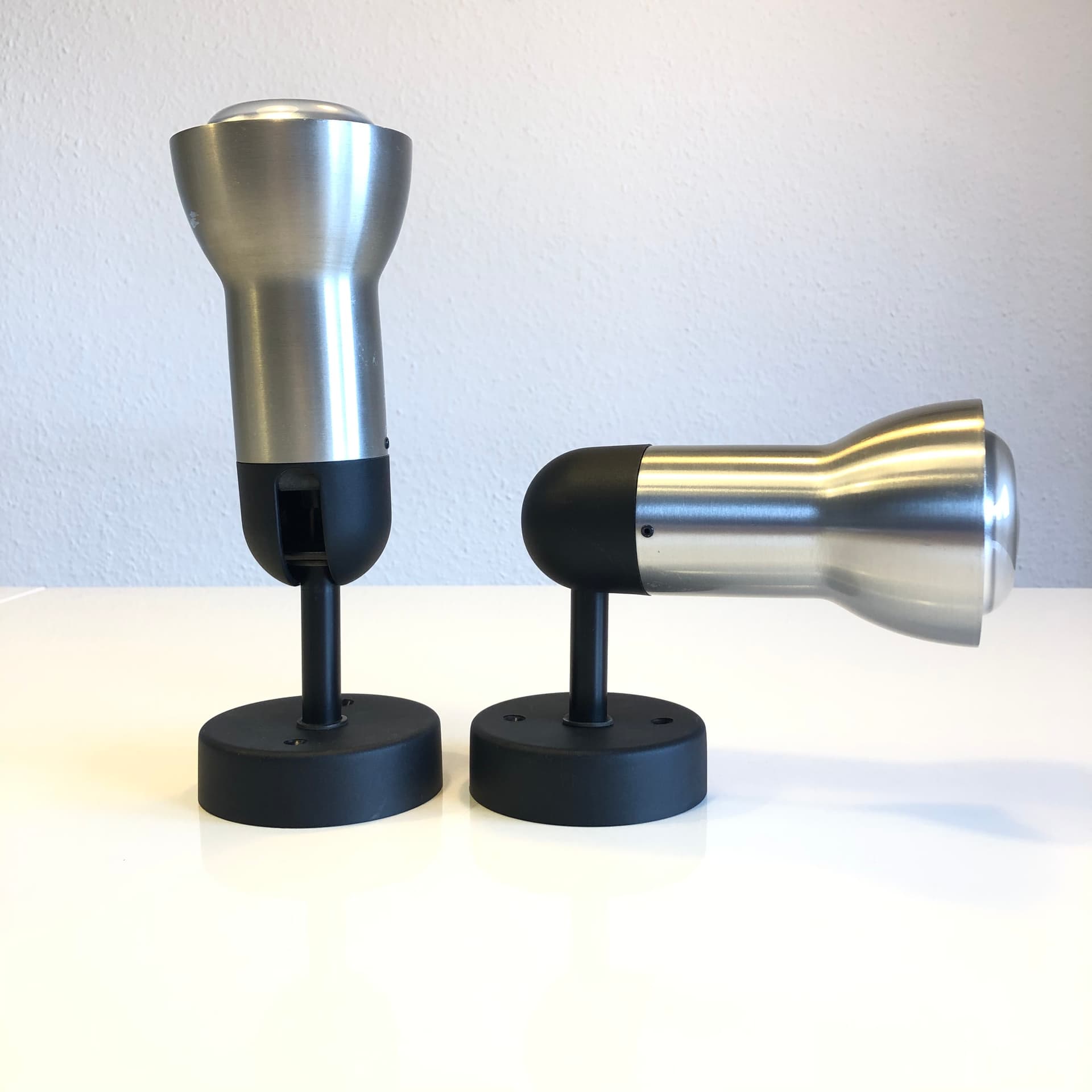 Pair of wall sconces, brushed silver aluminum, black metal, Staff Leuchten, Germany, 1970s. - 300618