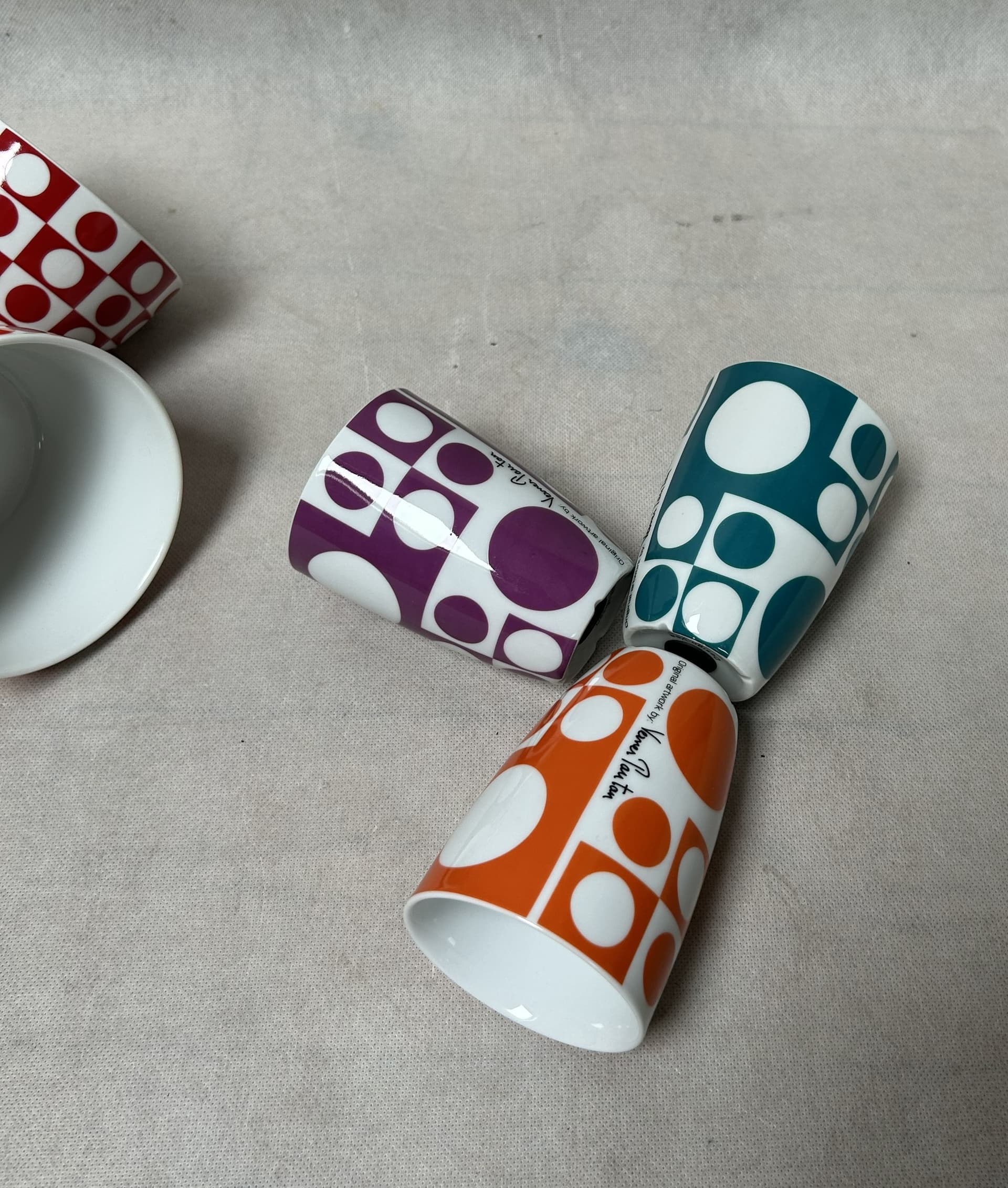 Set of mugs and bowls Geometri 1, white porcelain with purple, orange, blue, red decoration, by V. Panton, Denmark, 1960s. - 306506