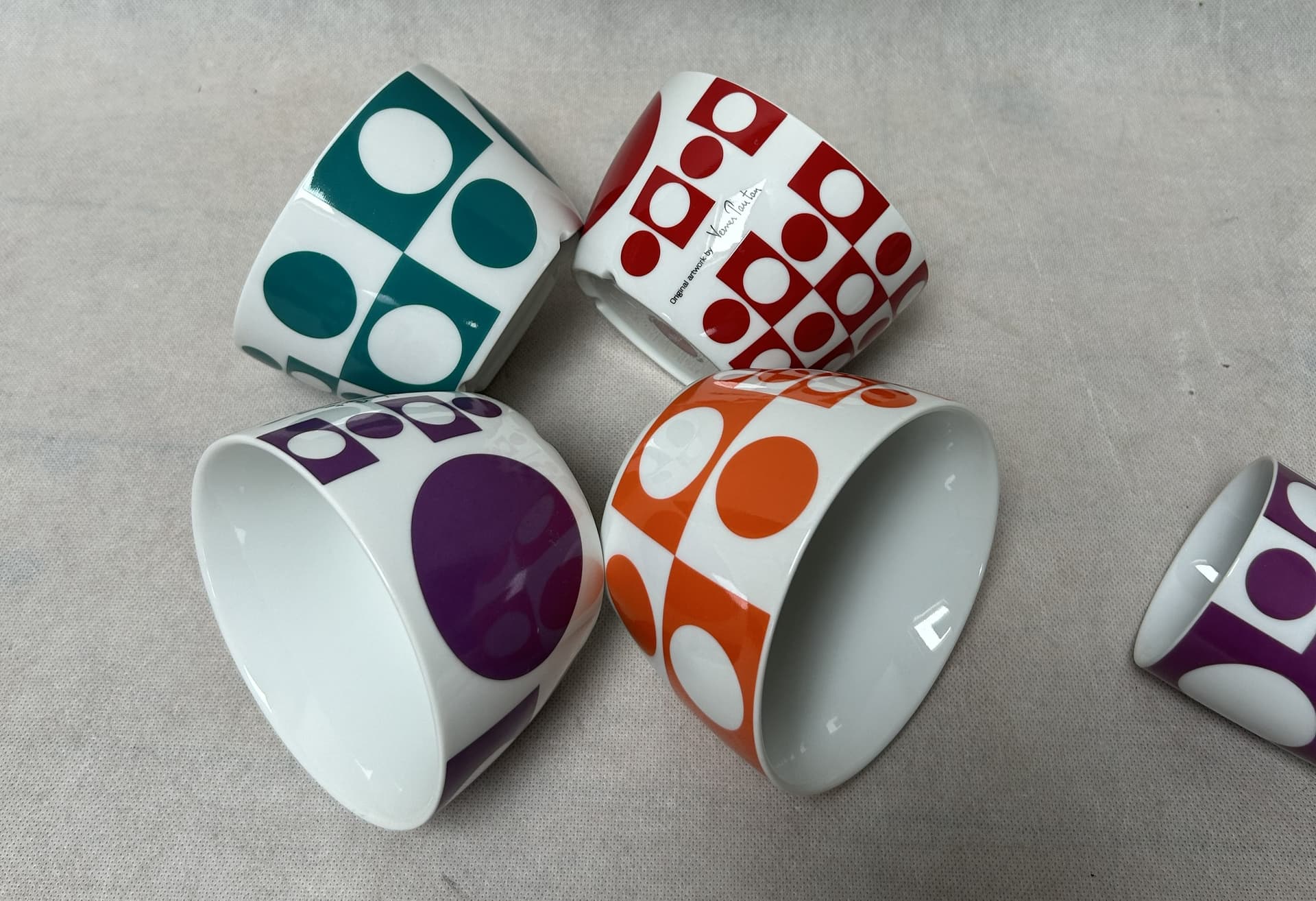 Set of mugs and bowls Geometri 1, white porcelain with purple, orange, blue, red decoration, by V. Panton, Denmark, 1960s. - 306507