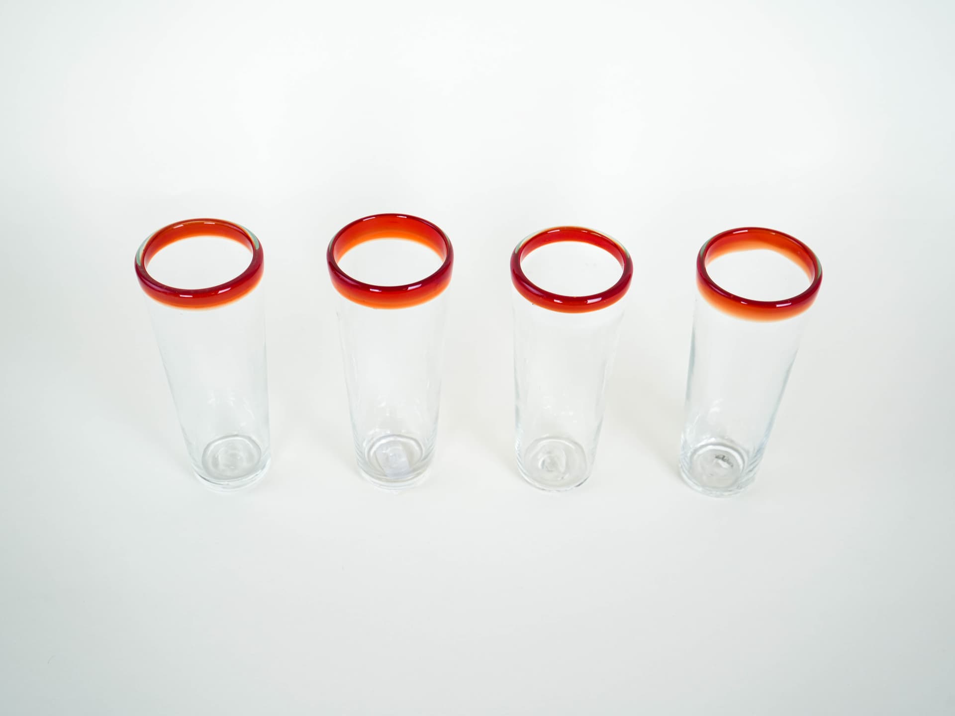 Set of four glasses, clear glass red-orange rim, Italy, 1970s. - 322060