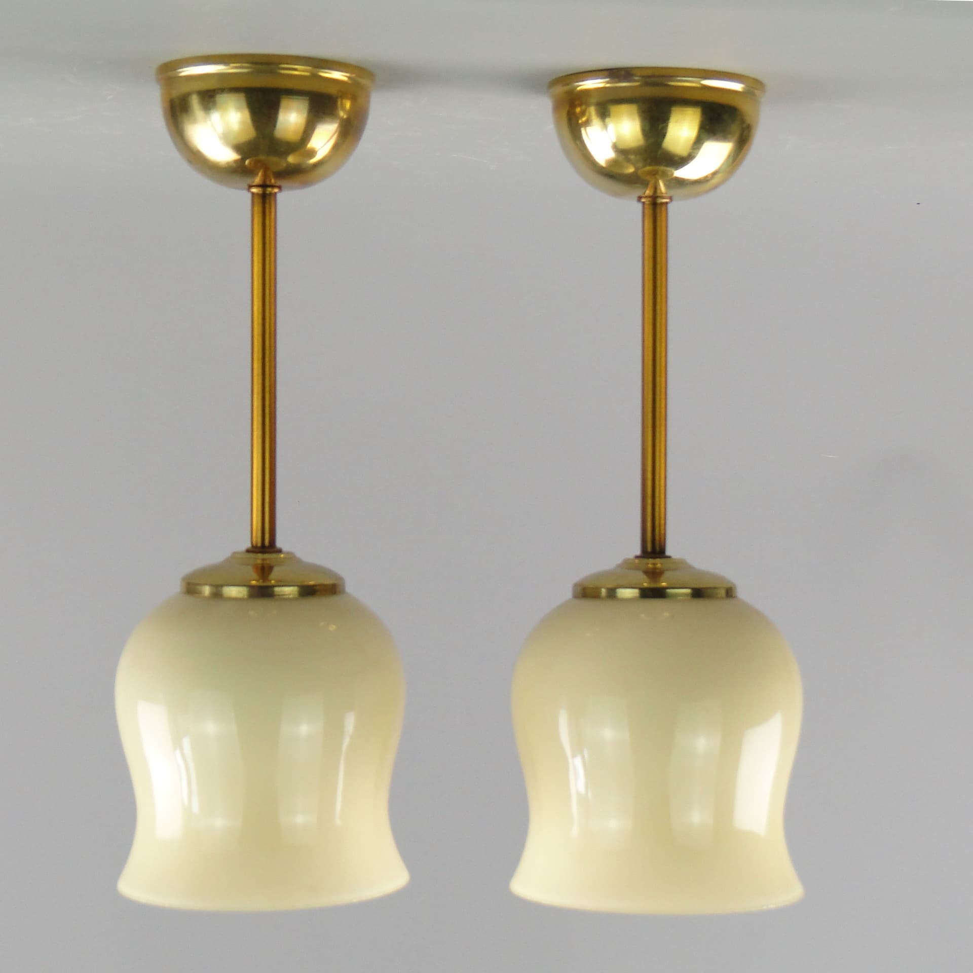 Pair of ceiling lamps, ecru glass, brass, Poland, 1950s. - 2618