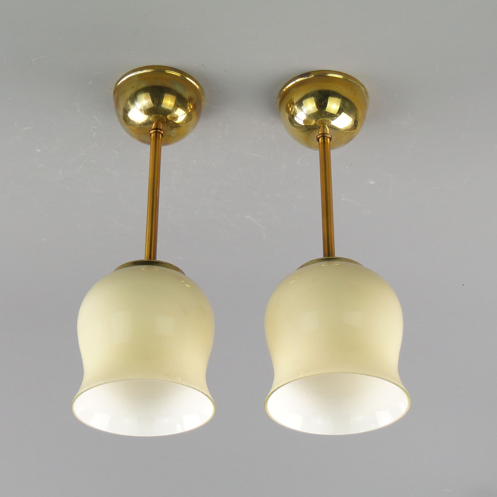 Pair of ceiling lamps, ecru glass, brass, Poland, 1950s. - 2617