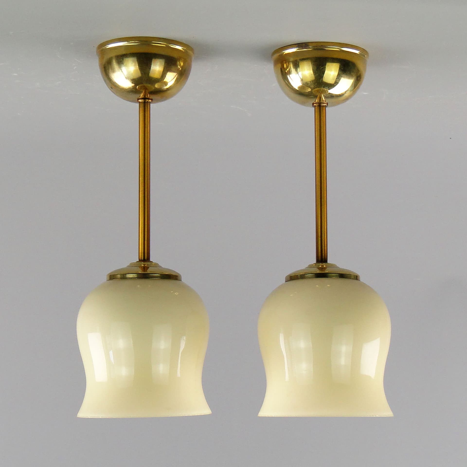 Pair of ceiling lamps, ecru glass, brass, Poland, 1950s. - 2615