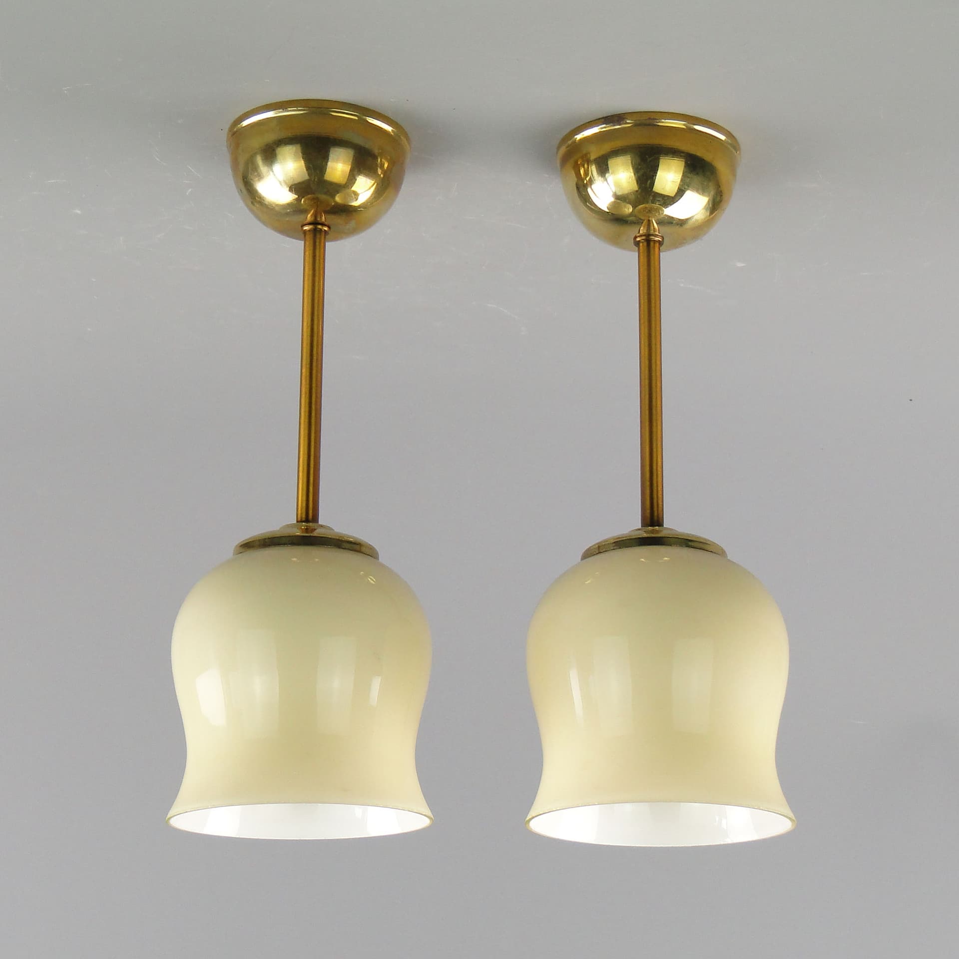 Pair of ceiling lamps, ecru glass, brass, Poland, 1950s. - 2616