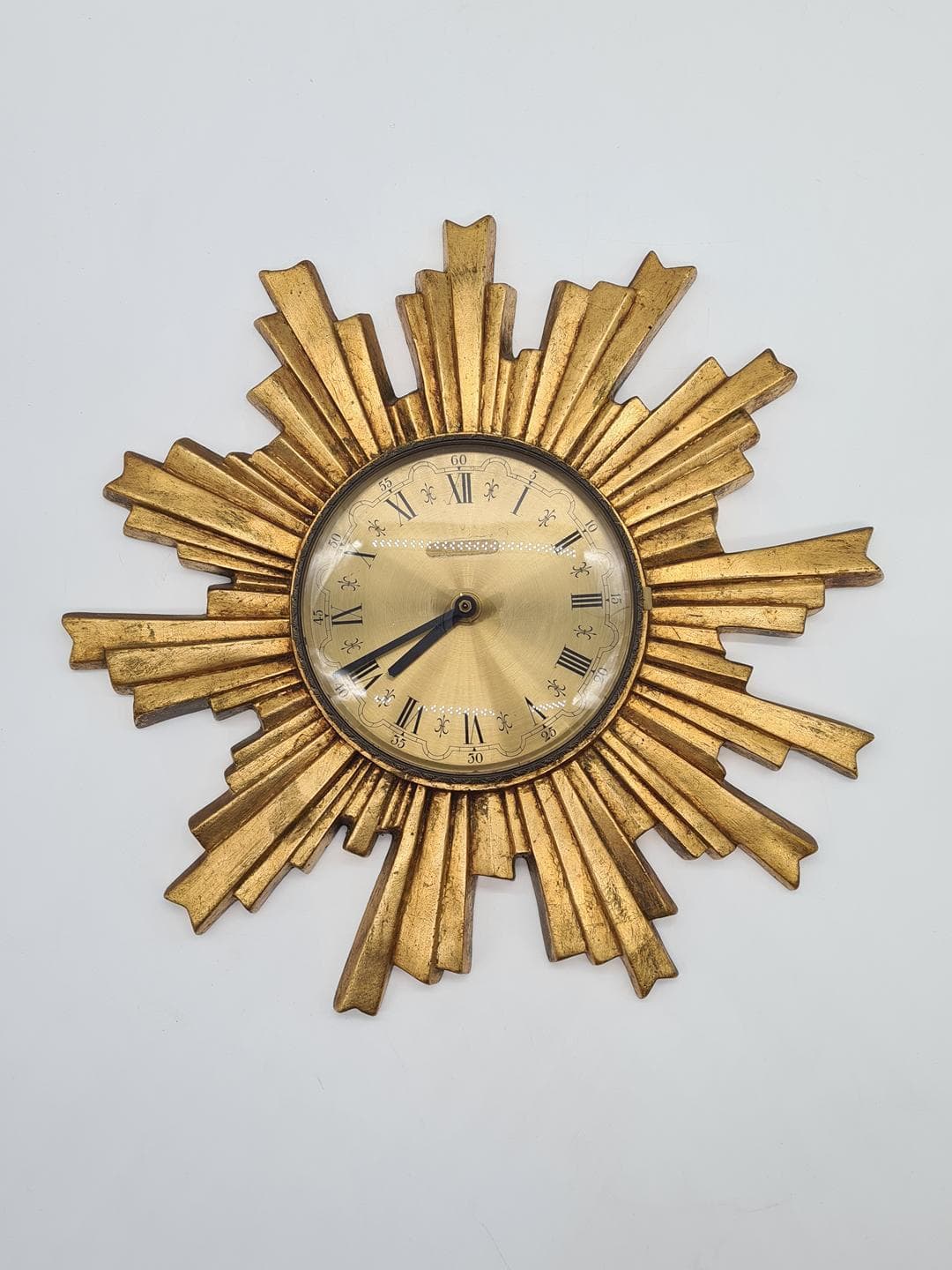 Wall Clock Sunburst, gold composite, black metal, glass, Germany, 1970s. - 326829