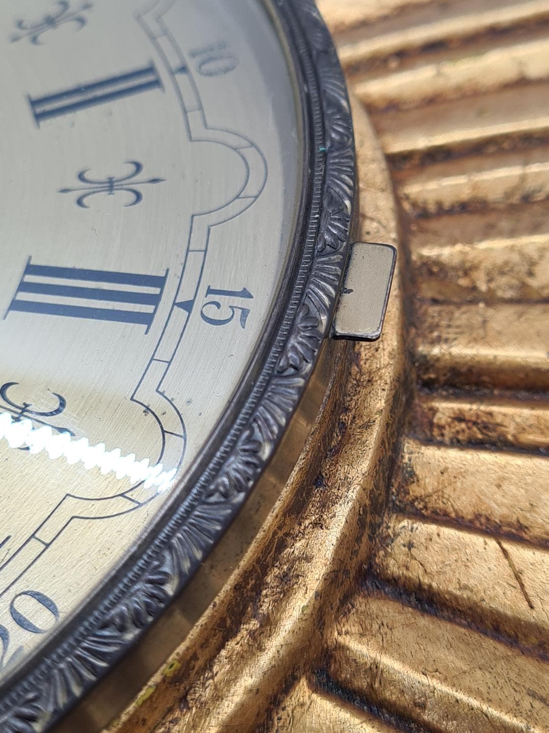 Wall Clock Sunburst, gold composite, black metal, glass, Germany, 1970s. - 326832