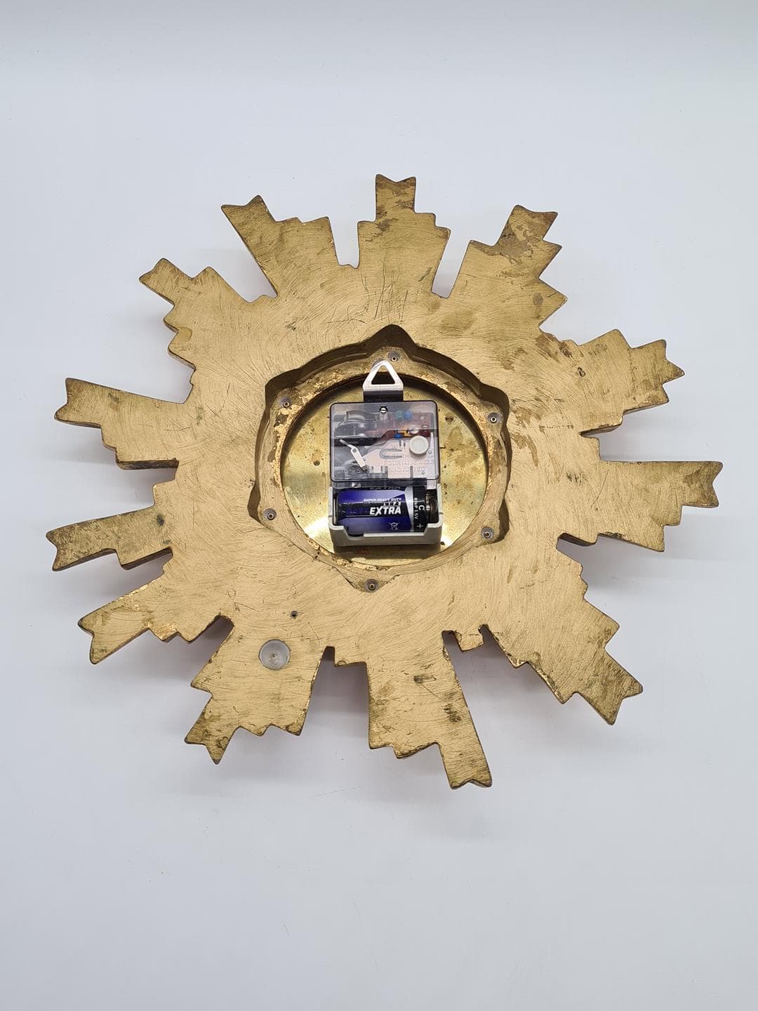 Wall Clock Sunburst, gold composite, black metal, glass, Germany, 1970s. - 326830