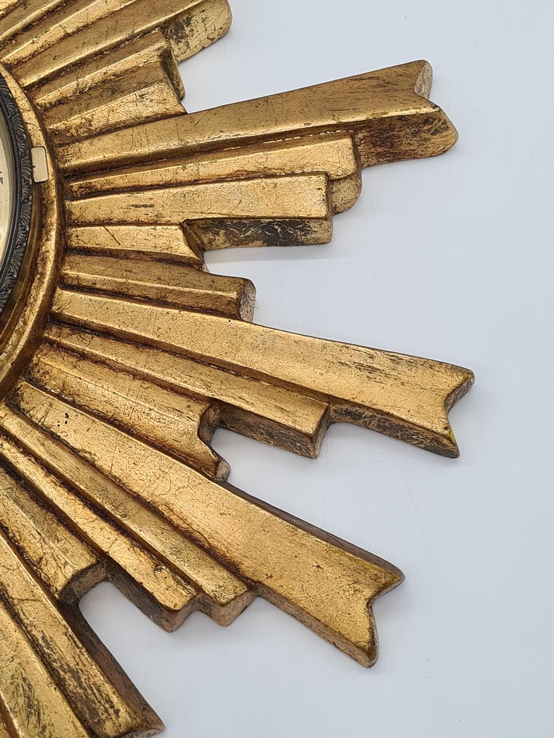 Wall Clock Sunburst, gold composite, black metal, glass, Germany, 1970s. - 326835