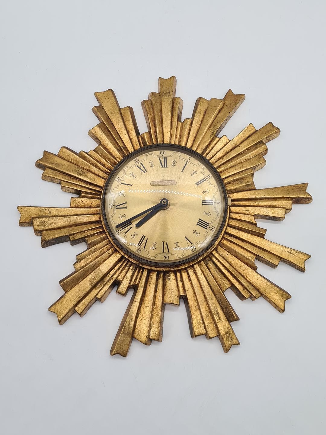 Wall Clock Sunburst, gold composite, black metal, glass, Germany, 1970s. - 326828