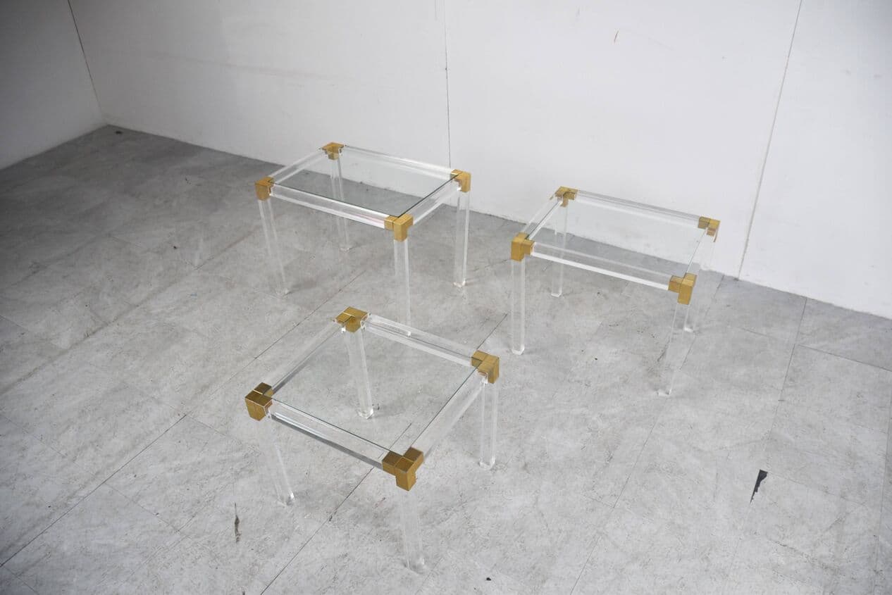 Set of three nesting tables, transparent lucite, brass, glass, Belgium, 1970s. - 329419
