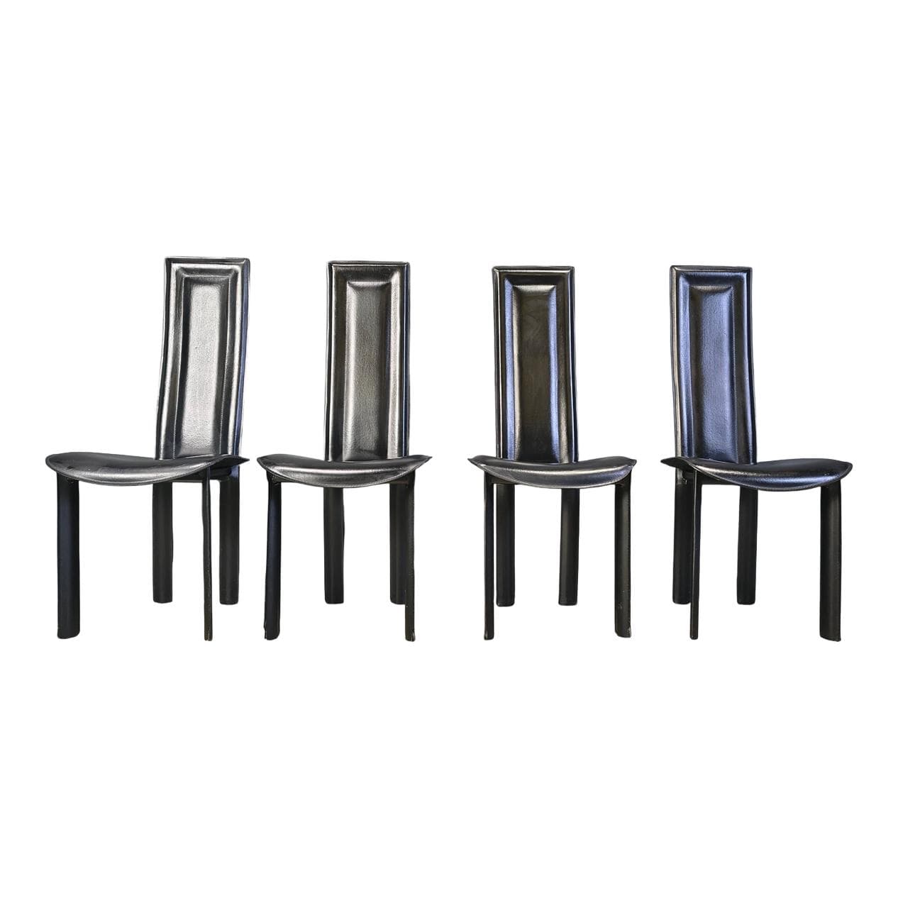 Set of four dining chairs, black leather, Italy, 1980s.