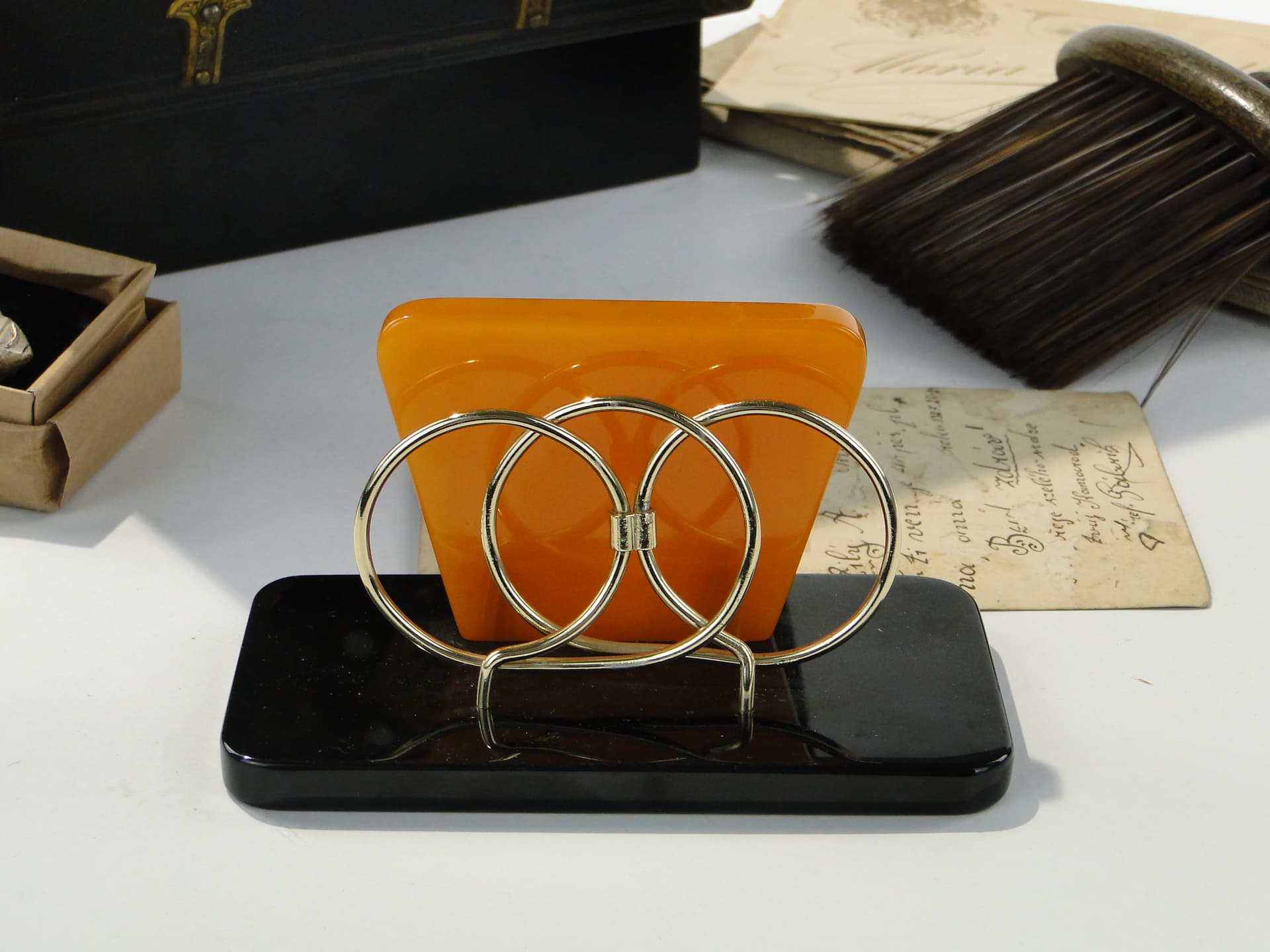 Napkin Holder, black and orange Bakelite, gold brass, Switzerland, 1960s. - 332844