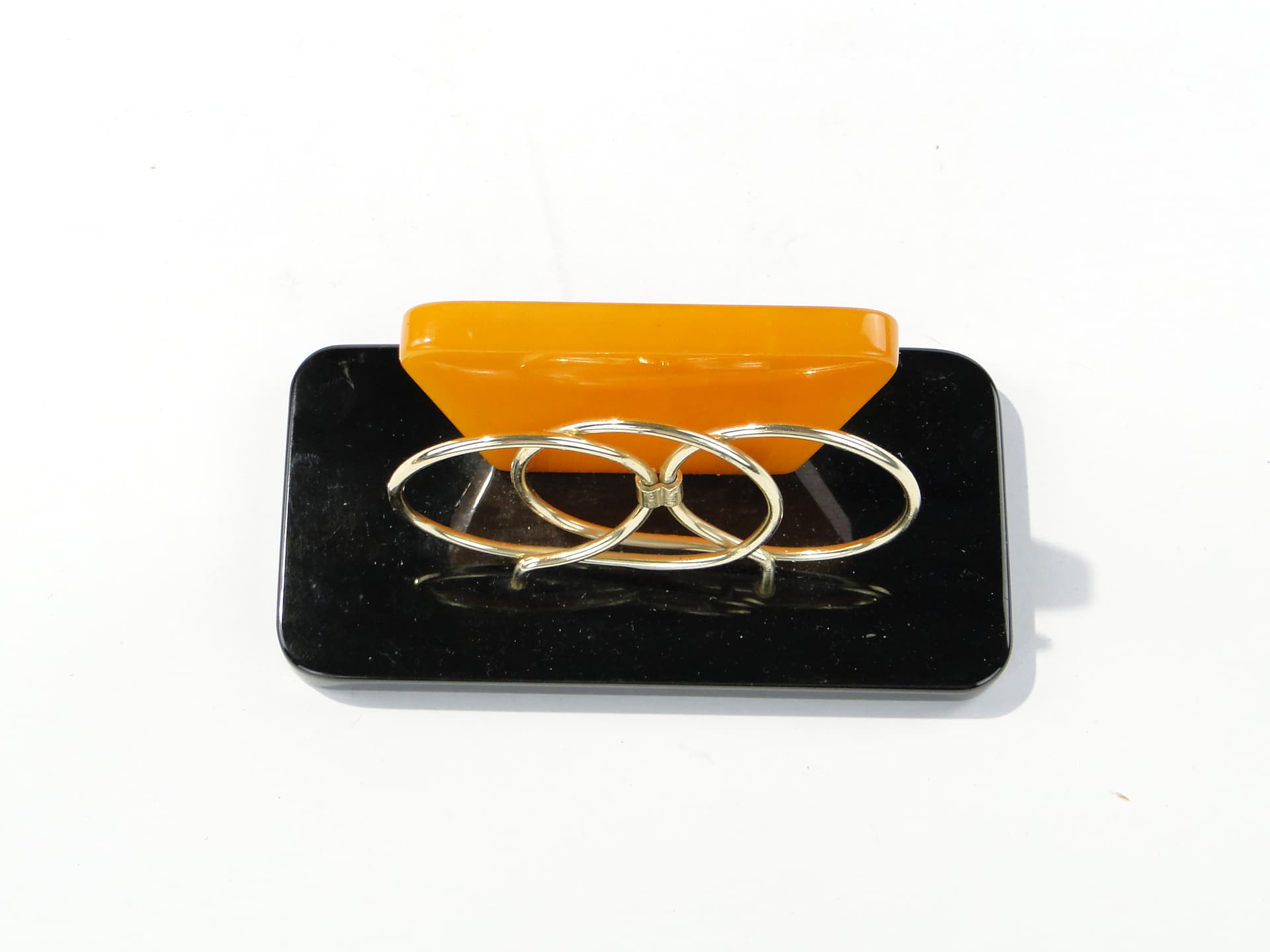 Napkin Holder, black and orange Bakelite, gold brass, Switzerland, 1960s. - 332849