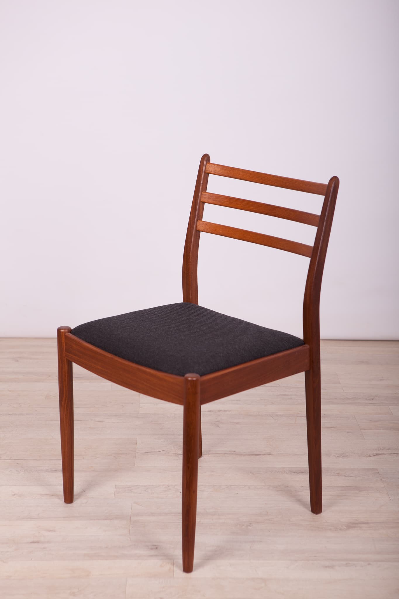 Set of four chairs, brown teak, black synthetic fabric, by V. Wilkins, G-Plan, United Kingdom, 1960s. - 333006