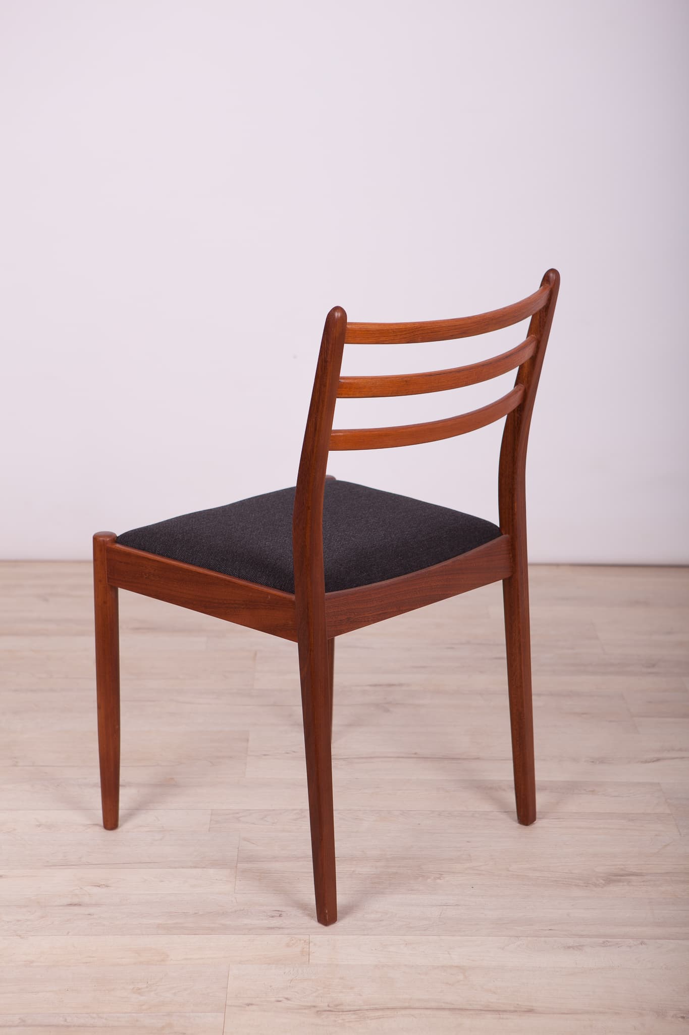 Set of four chairs, brown teak, black synthetic fabric, by V. Wilkins, G-Plan, United Kingdom, 1960s. - 333011