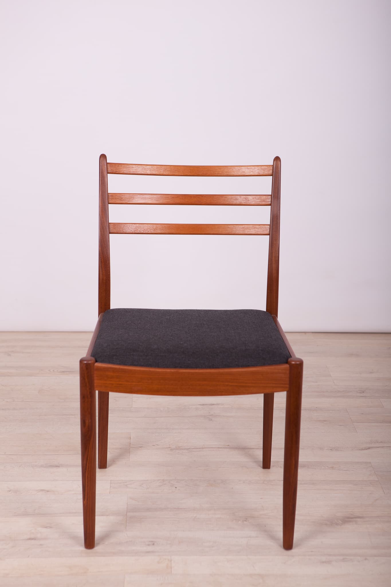 Set of four chairs, brown teak, black synthetic fabric, by V. Wilkins, G-Plan, United Kingdom, 1960s. - 333009