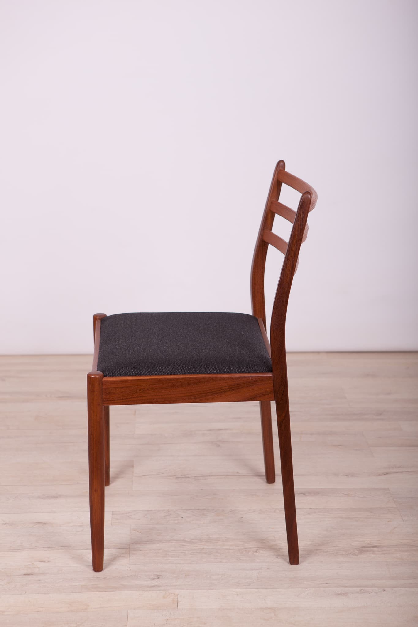Set of four chairs, brown teak, black synthetic fabric, by V. Wilkins, G-Plan, United Kingdom, 1960s. - 333008