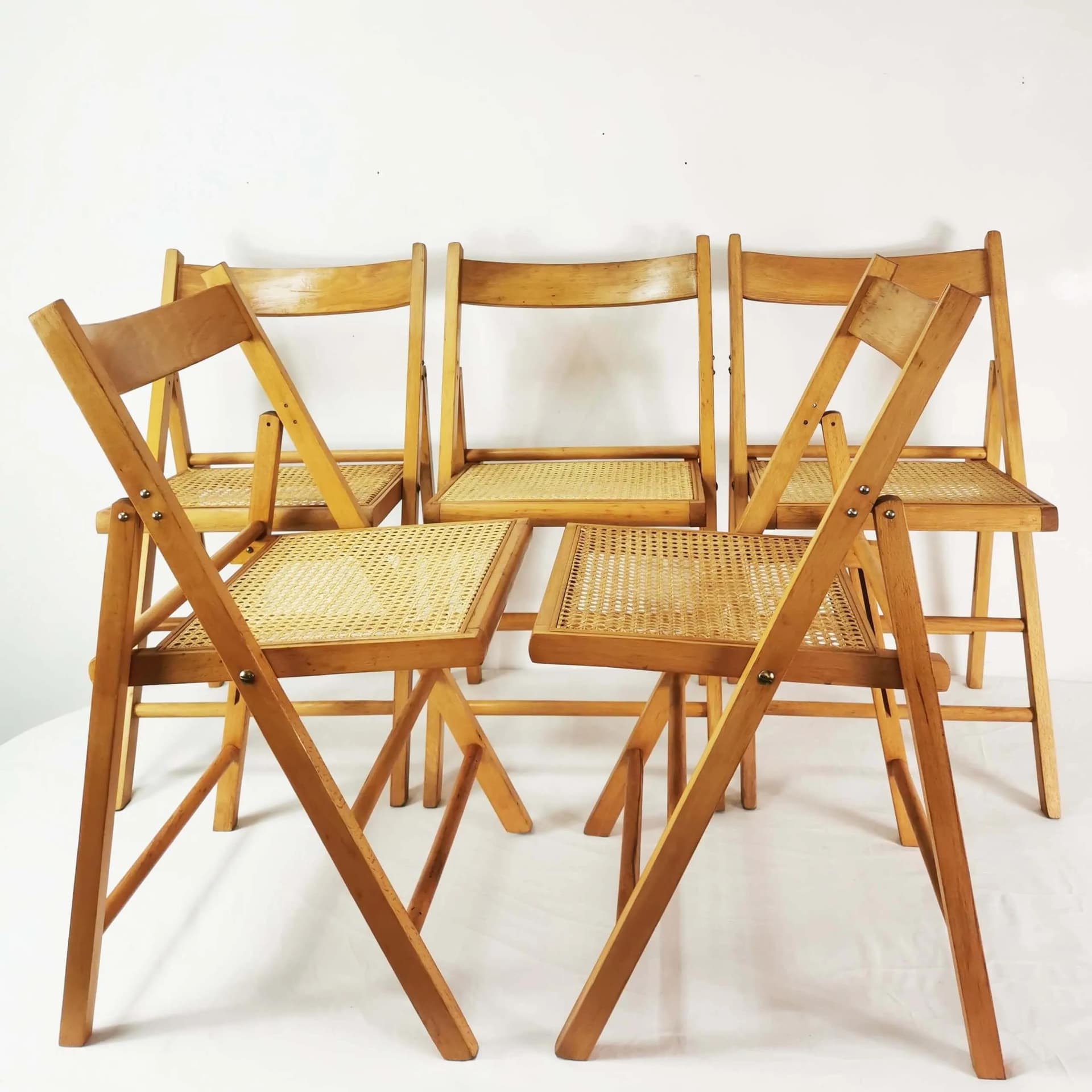 Set of five folding chairs, brown beech, beige raffia, Germany, 1980s. - 340524