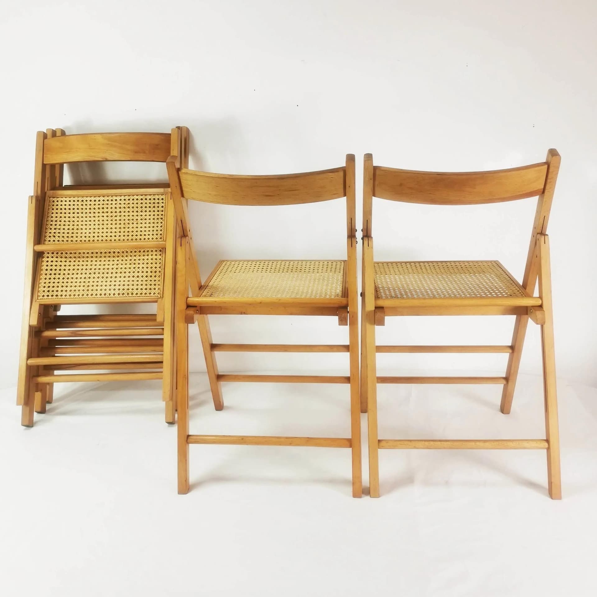 Set of five folding chairs, brown beech, beige raffia, Germany, 1980s. - 340526