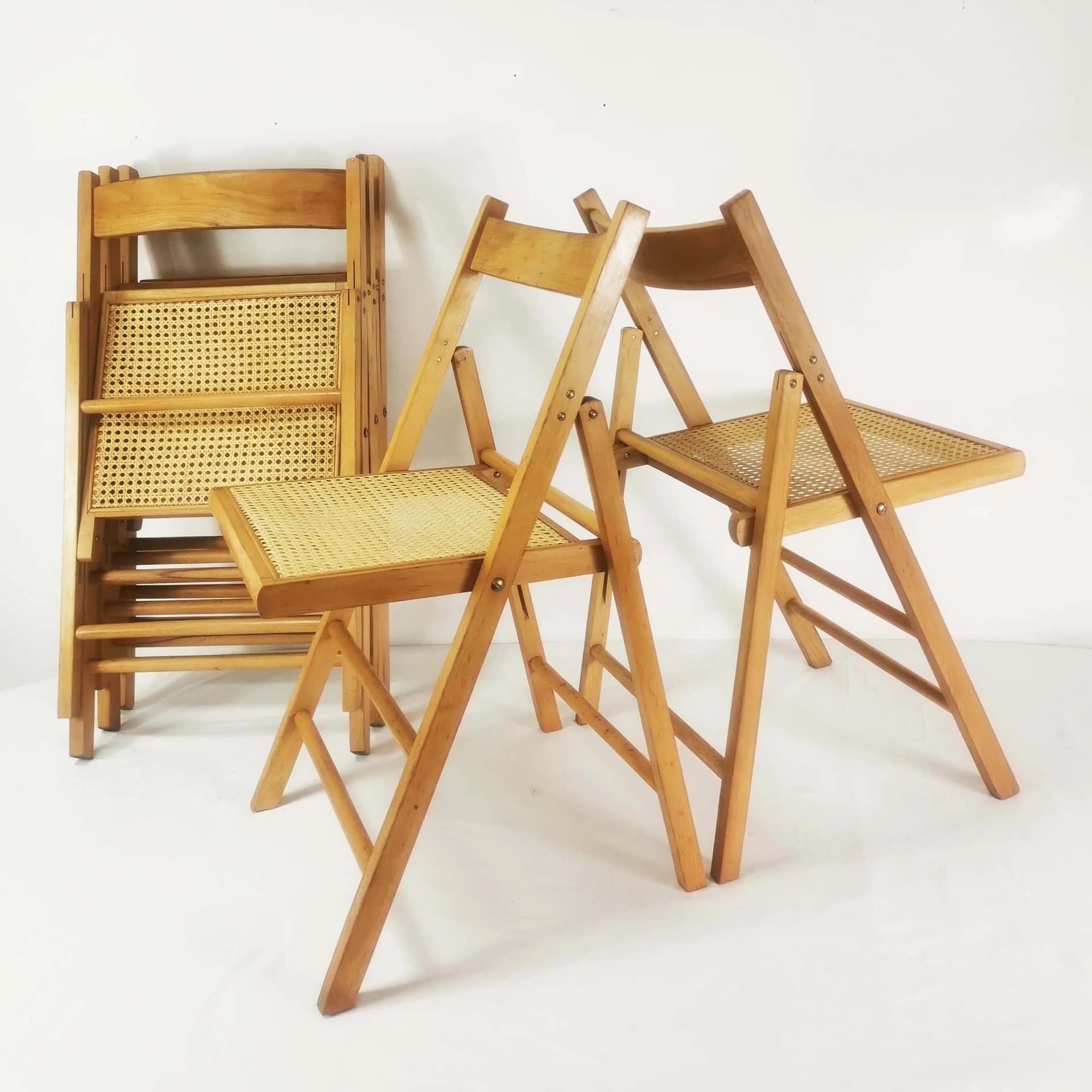 Set of five folding chairs, brown beech, beige raffia, Germany, 1980s. - 340525