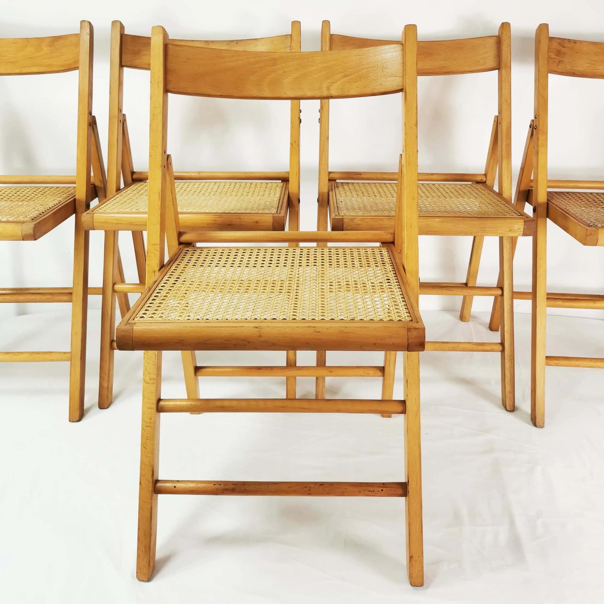 Set of five folding chairs, brown beech, beige raffia, Germany, 1980s. - 340528