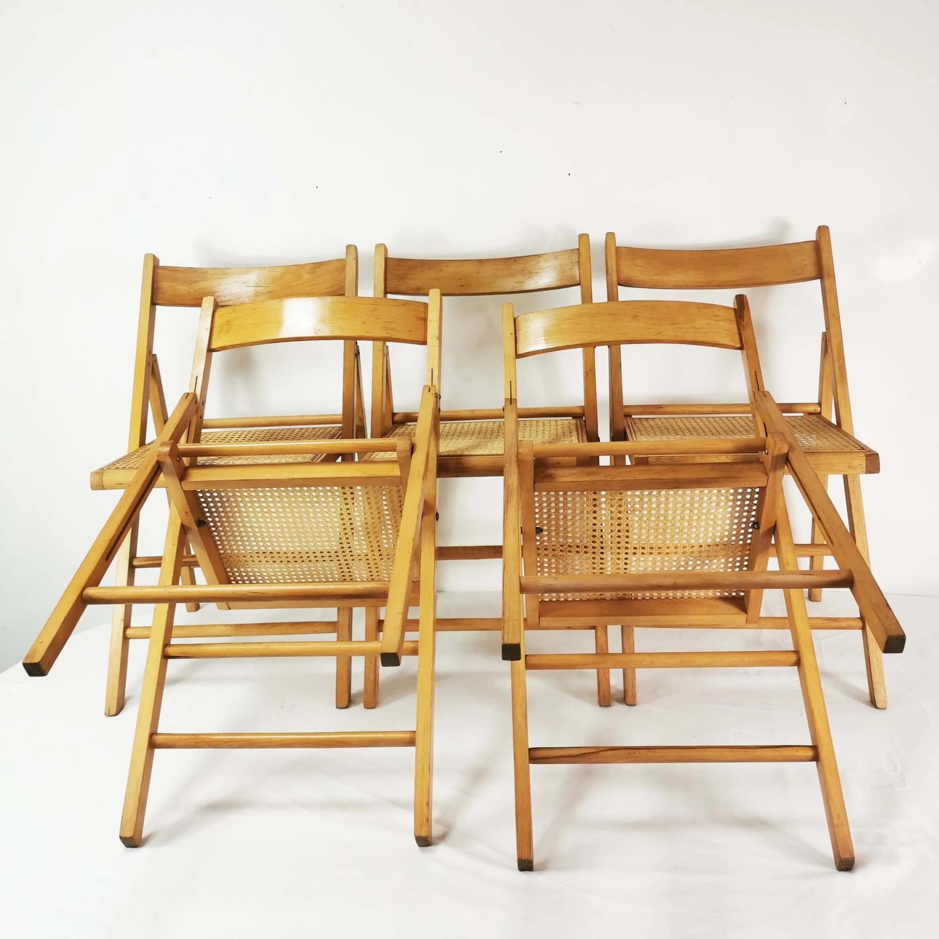 Set of five folding chairs, brown beech, beige raffia, Germany, 1980s. - 340529