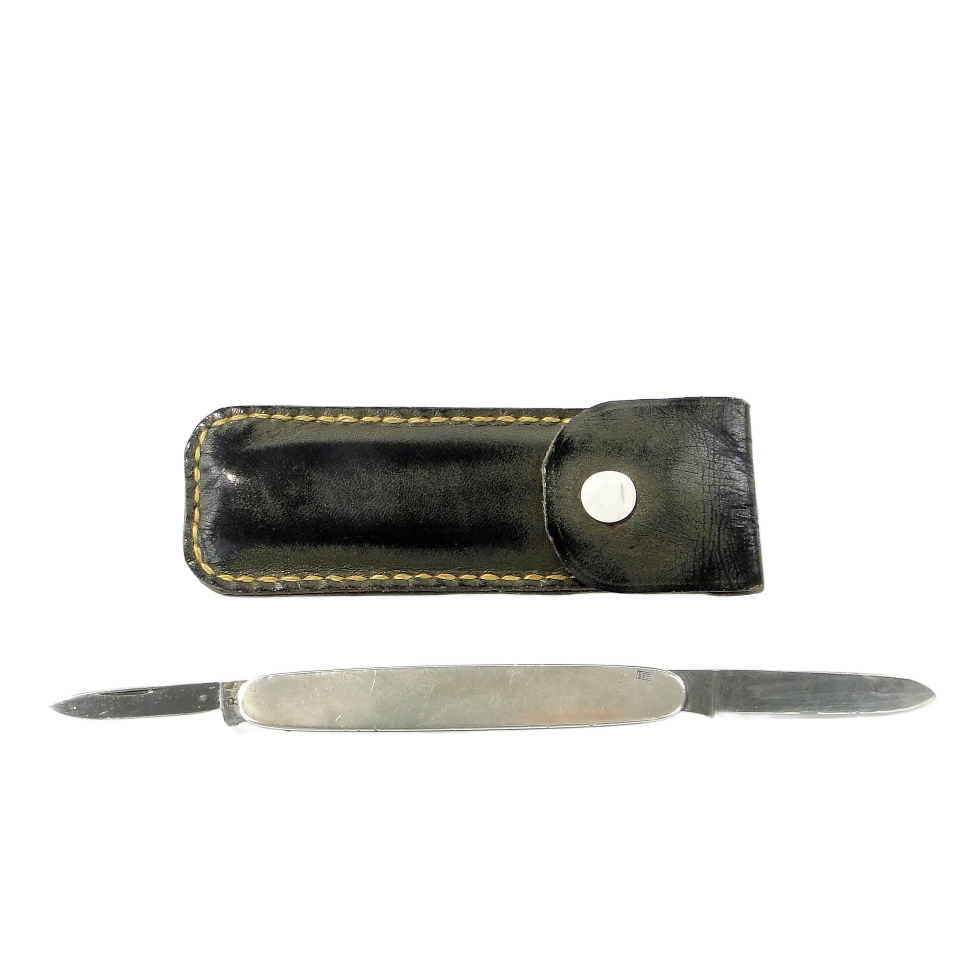 Pocket knife, silver, steel, black leather, United Kingdom, 1960s.