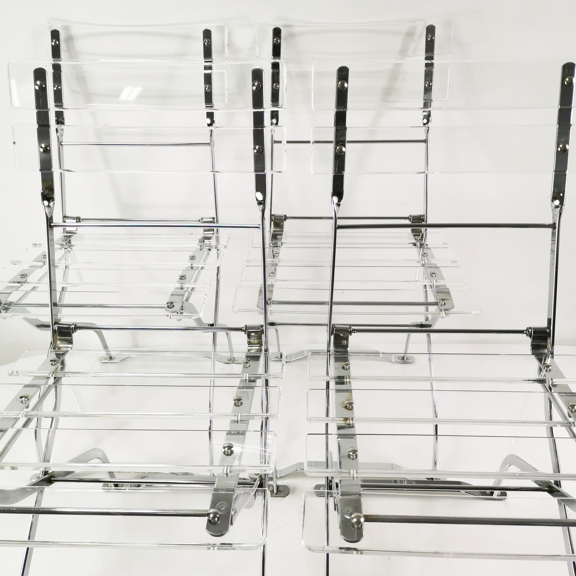 Set of four folding chairs, transparent plexiglass, silver metal, France, 1970s. - 347508