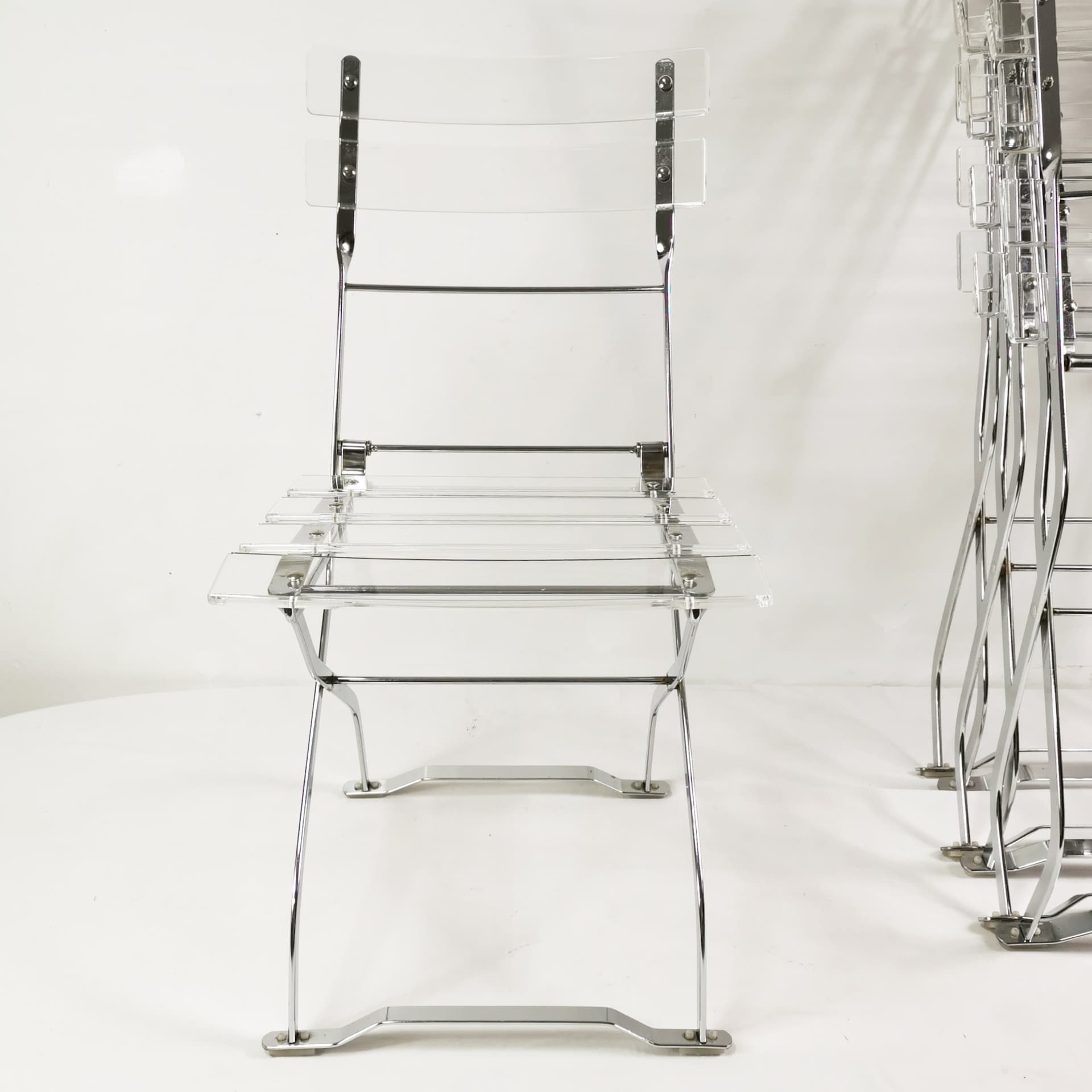 Set of four folding chairs, transparent plexiglass, silver metal, France, 1970s. - 347515