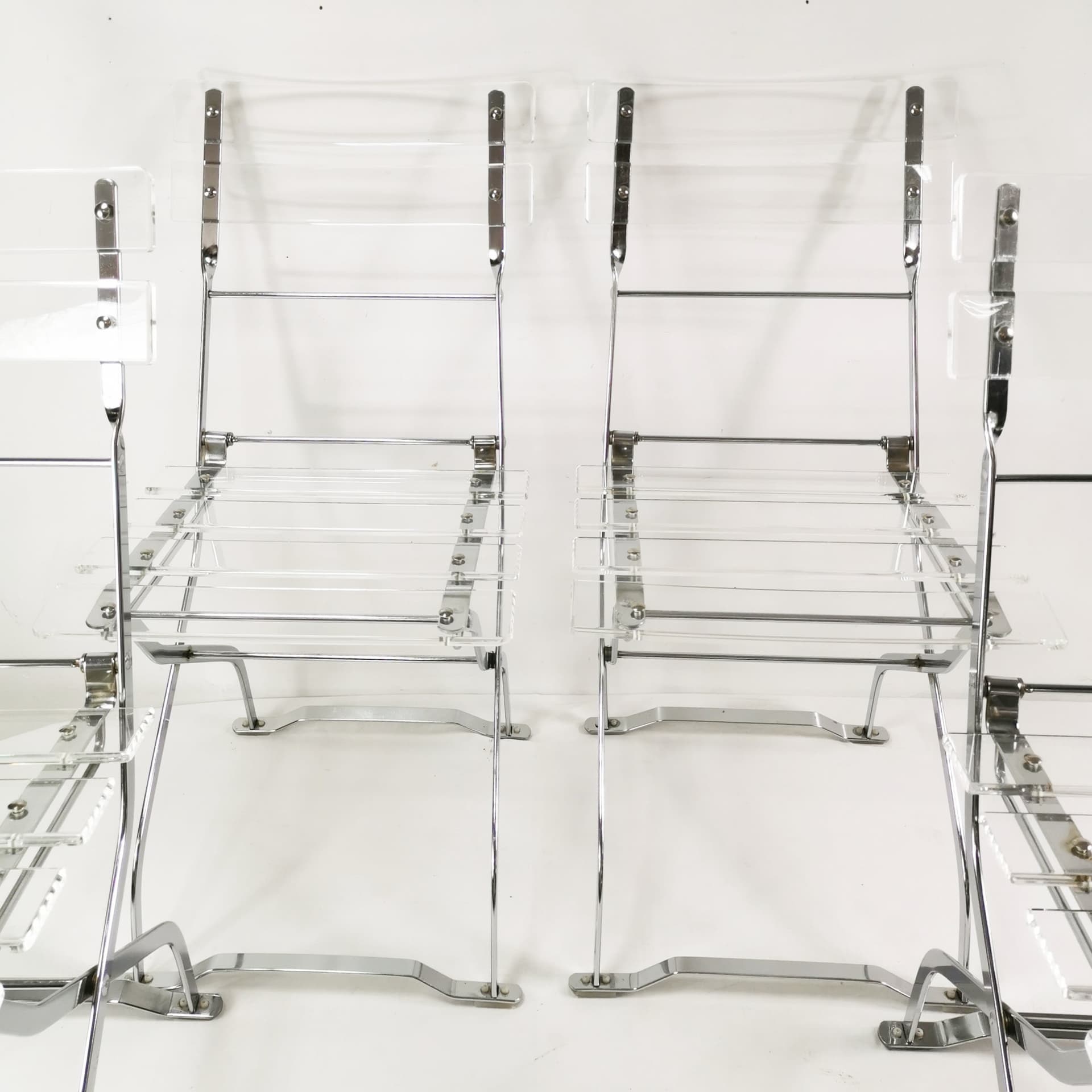 Set of four folding chairs, transparent plexiglass, silver metal, France, 1970s. - 347509