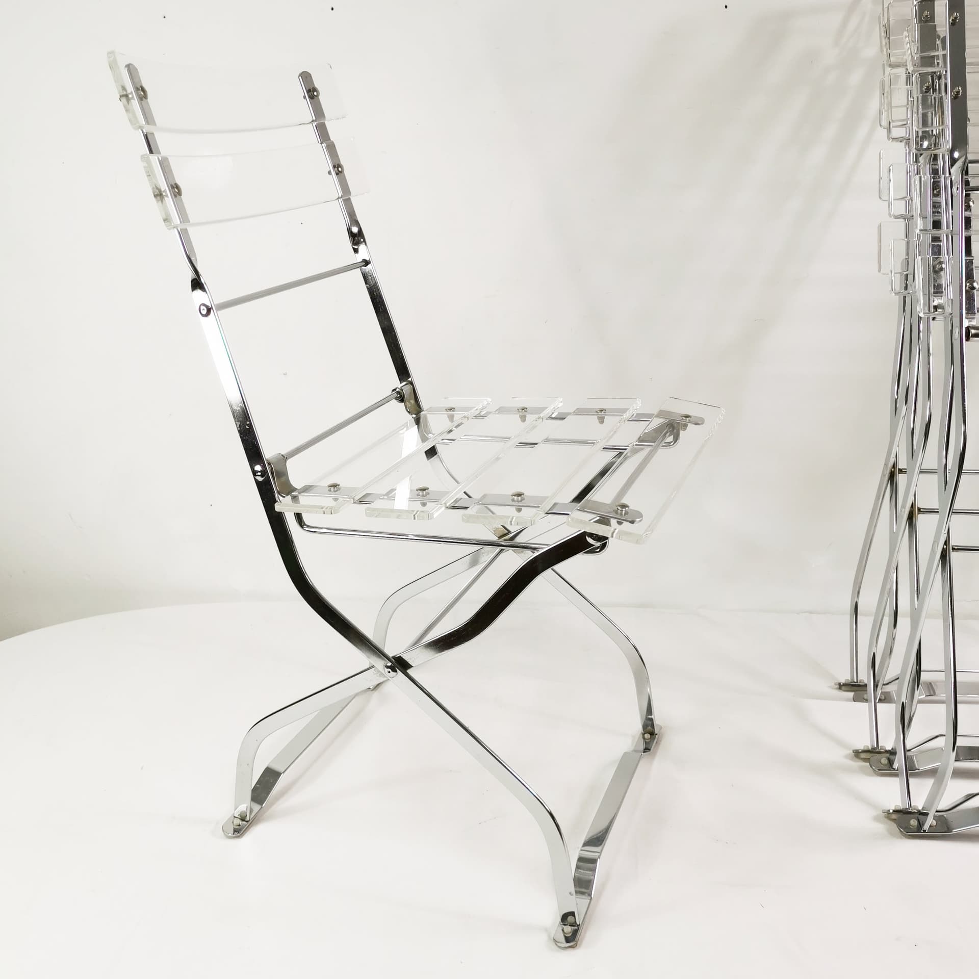 Set of four folding chairs, transparent plexiglass, silver metal, France, 1970s. - 347516