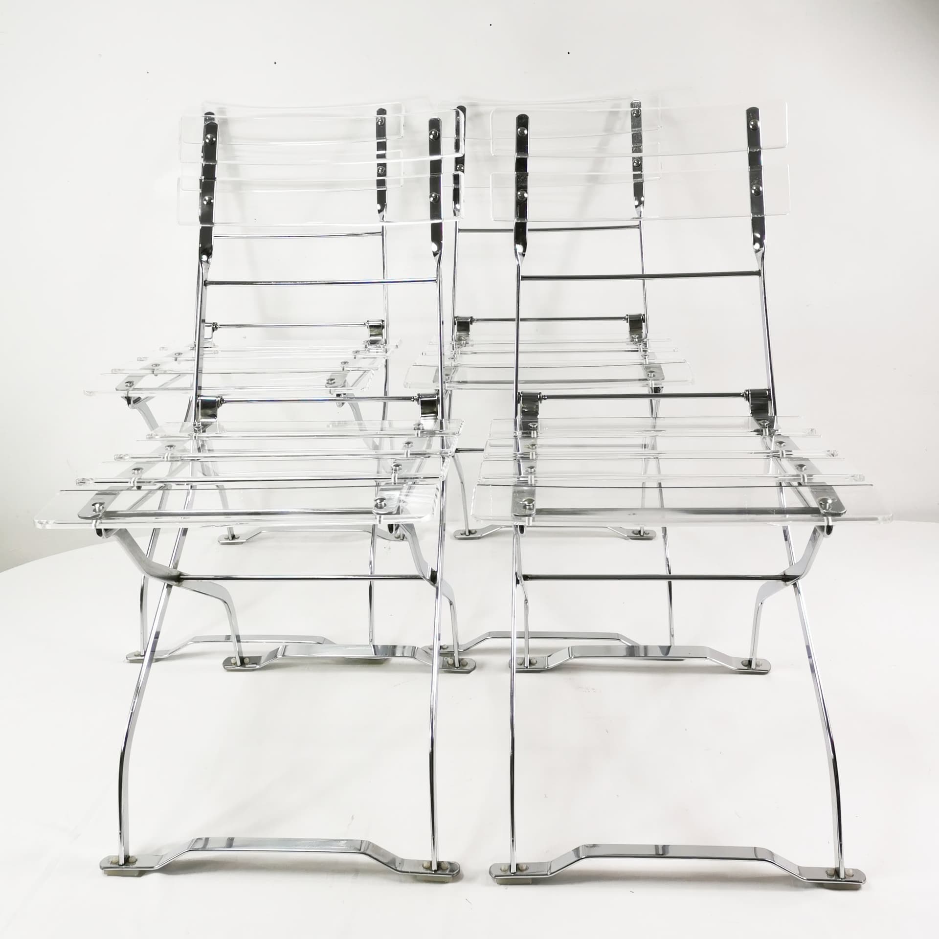 Set of four folding chairs, transparent plexiglass, silver metal, France, 1970s. - 347507