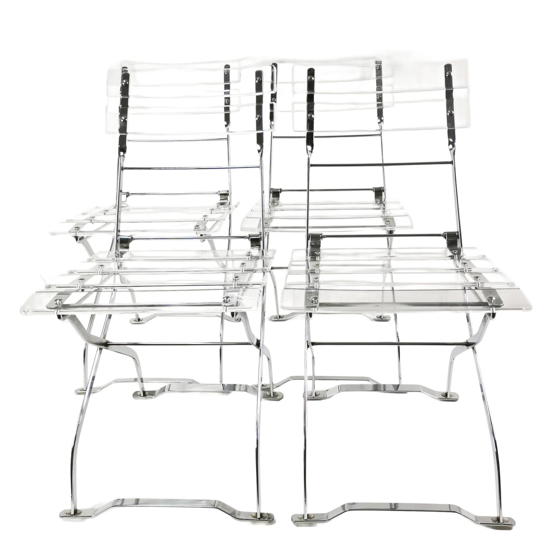 Set of four folding chairs, transparent plexiglass, silver metal, France, 1970s.