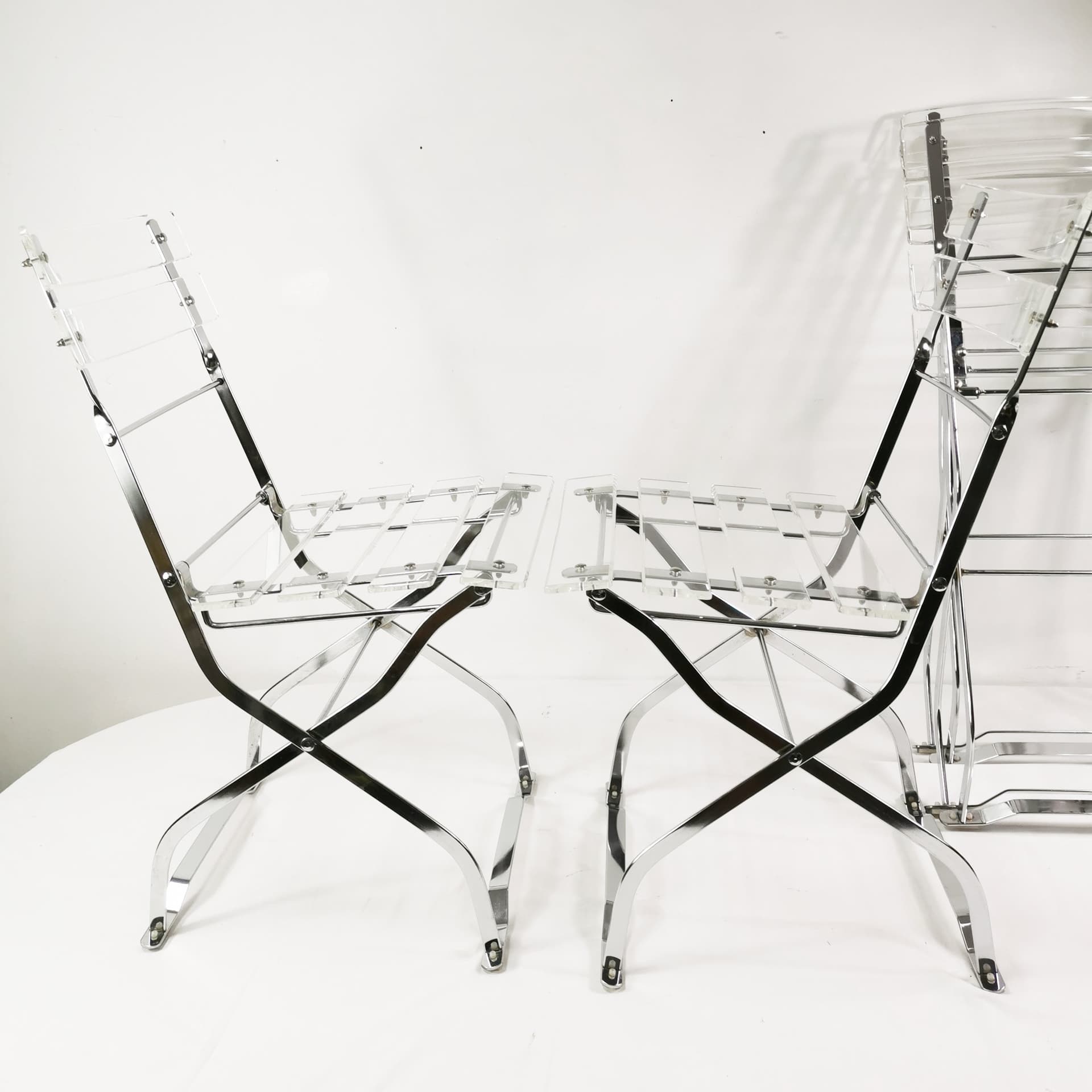 Set of four folding chairs, transparent plexiglass, silver metal, France, 1970s. - 347513