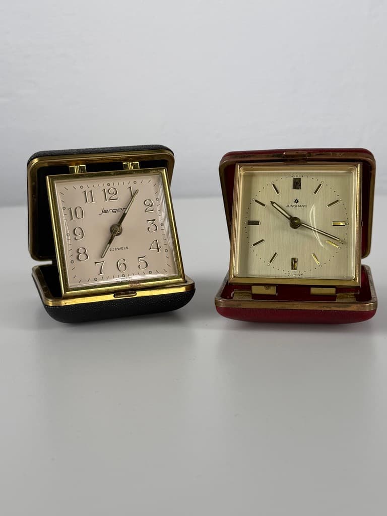 Set of two travel clocks, Junghans & Jerger, gold brass, black and burgundy faux leather, Germany, 1960s. - 364760