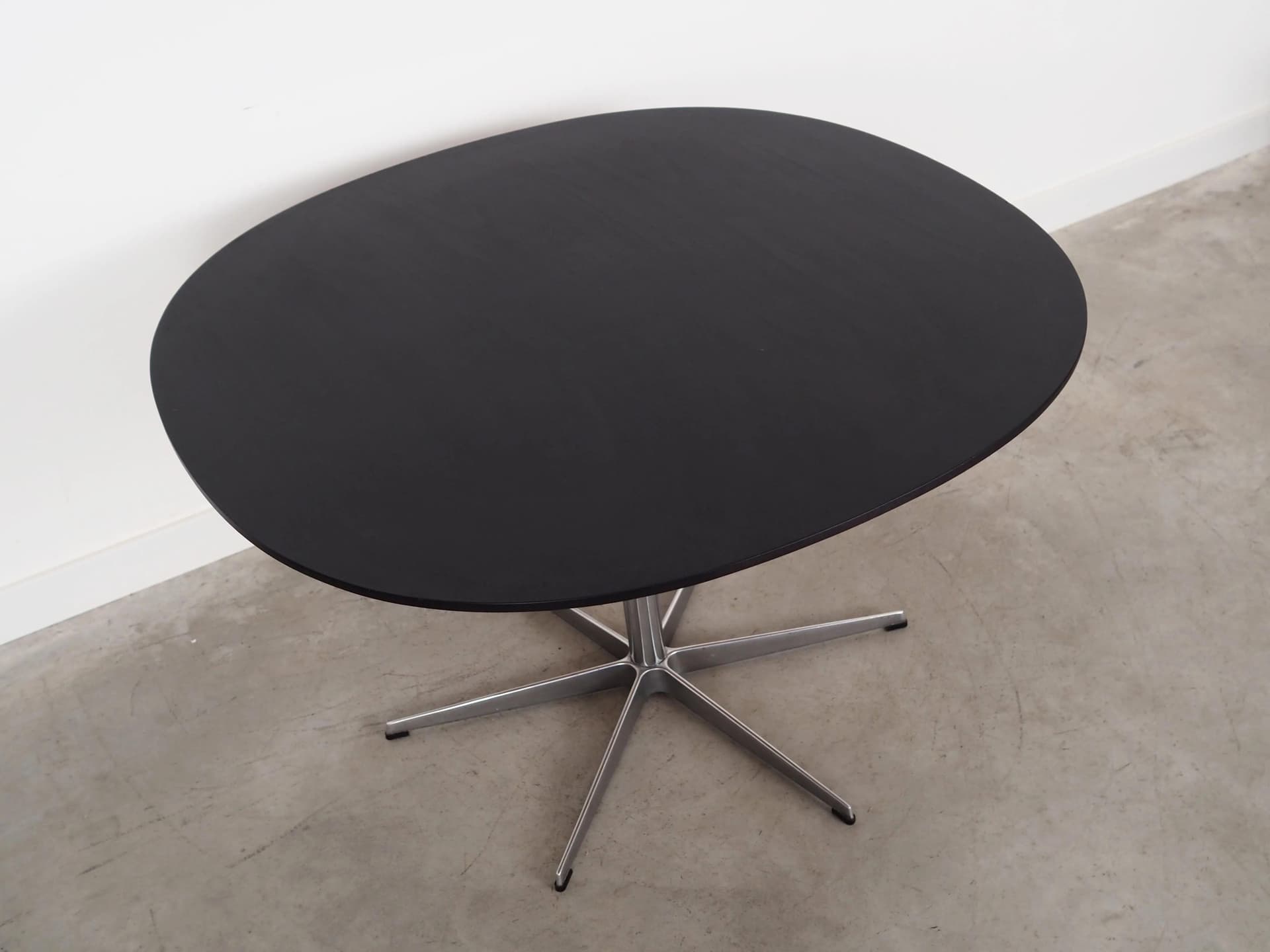 Round table, black ash, grey metal, by A. Jacobsen, Fritz Hansen, Denmark, 1960s. - 27977