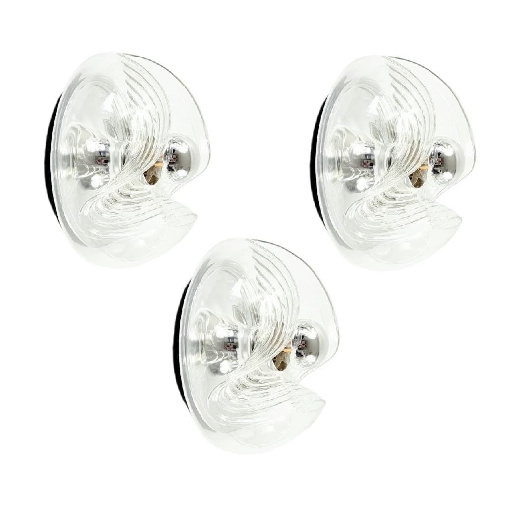 Set of three wall sconces Wave/Futura, transparent glass, silver aluminium, Peill & Putzler, Germany, 1970s.