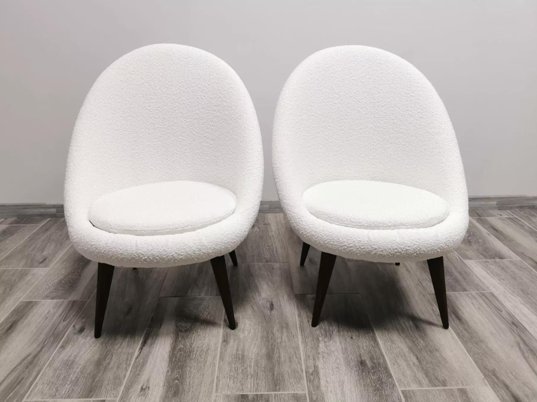 Pair of armchairs, white bouclé, wood, by L. Volak, Tatra Nabytok, Czechoslovakia, 1950s. - 48520
