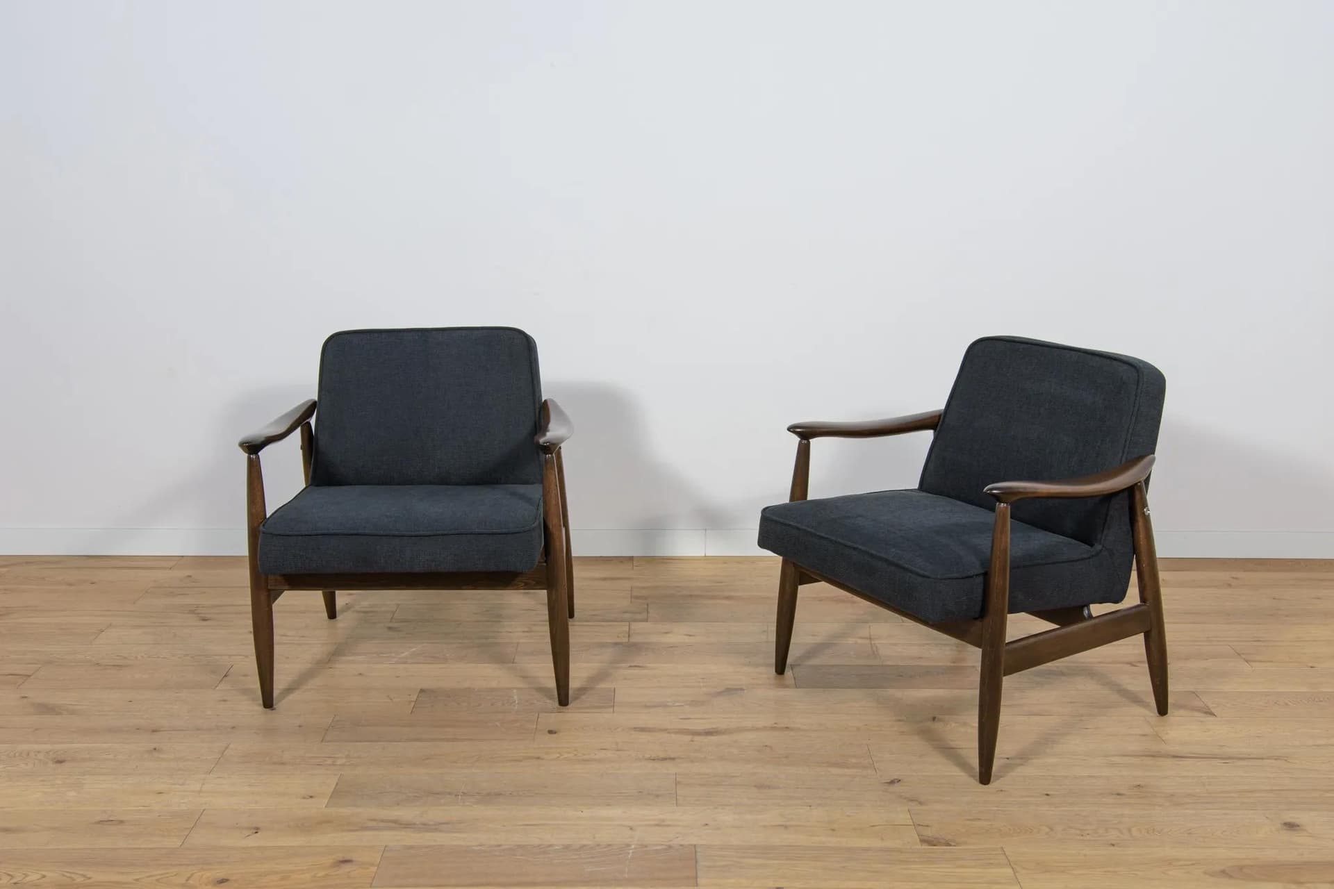Pair of armchairs GFM-87, brown wood, black fabric, by J. Kędziorek, Poland, 1970s. - 70467